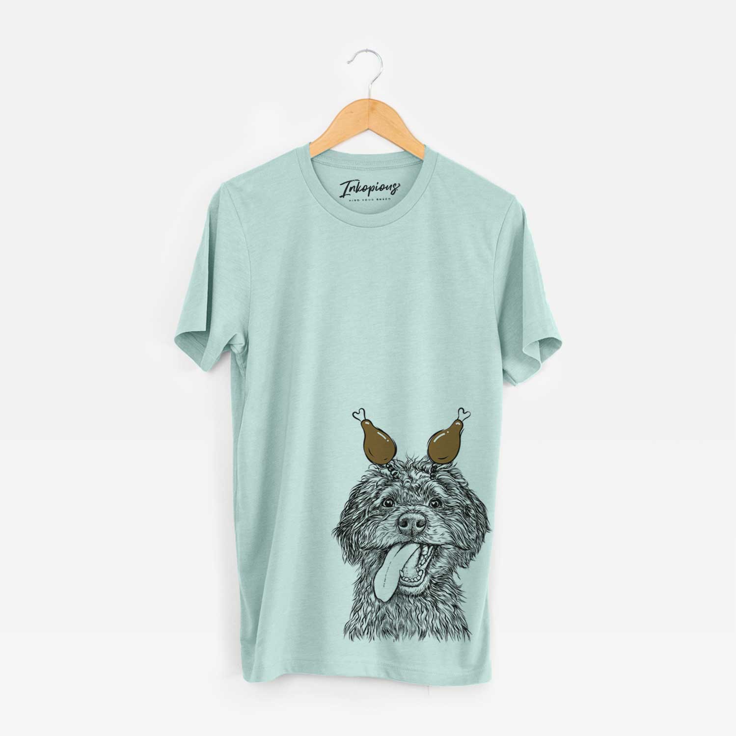 Hand-drawn sketch of Winnie the Mini Aussiedoodle with a Thanksgiving turkey headpiece on a Heather Sage Unisex crewneck