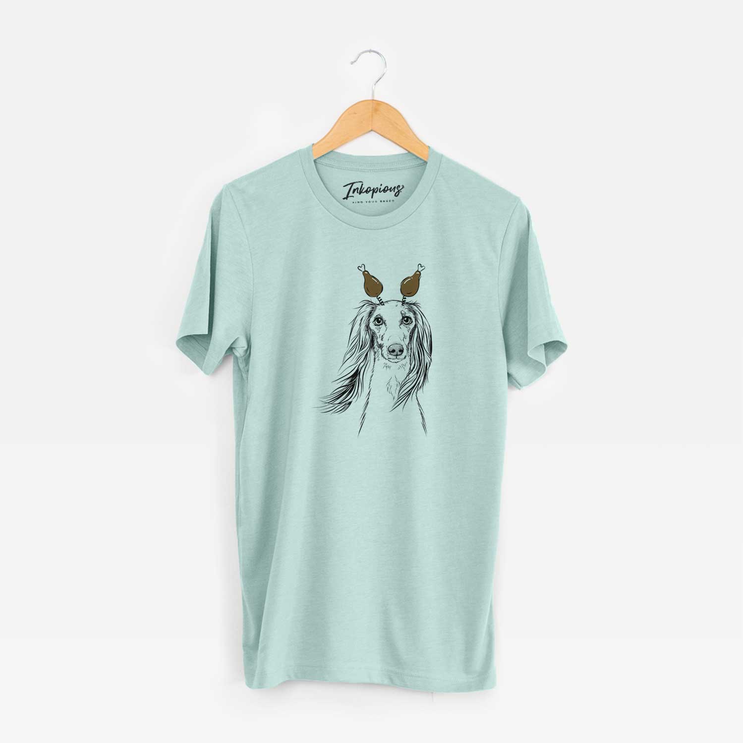 Hand-drawn sketch of Zahra the Saluki with a Thanksgiving turkey headpiece on a Heather Sage Unisex crewneck