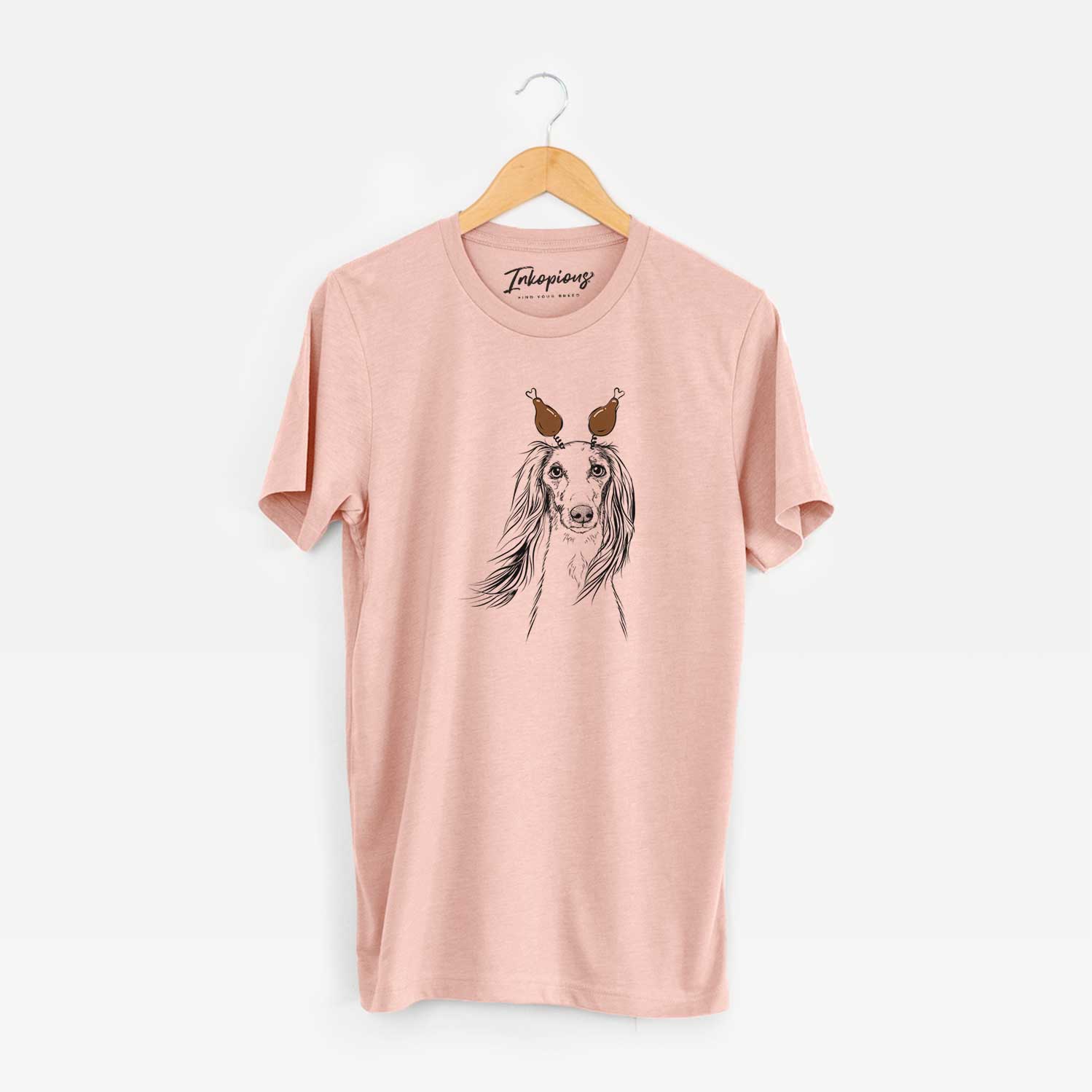 Hand-drawn sketch of Zahra the Saluki with a Thanksgiving turkey headpiece on a Peach Unisex crewneck