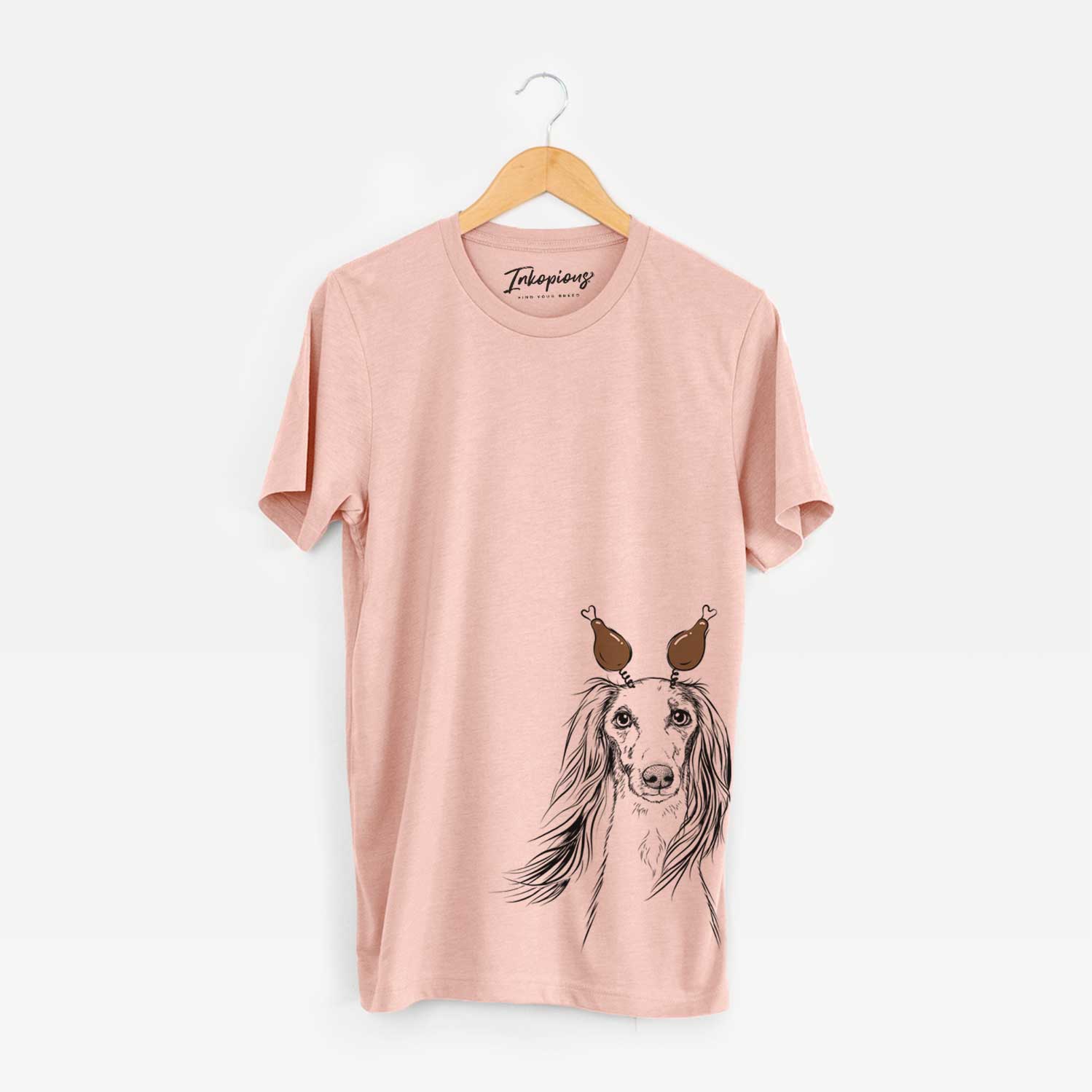 Hand-drawn sketch of Zahra the Saluki with a Thanksgiving turkey headpiece on a Peach Unisex crewneck