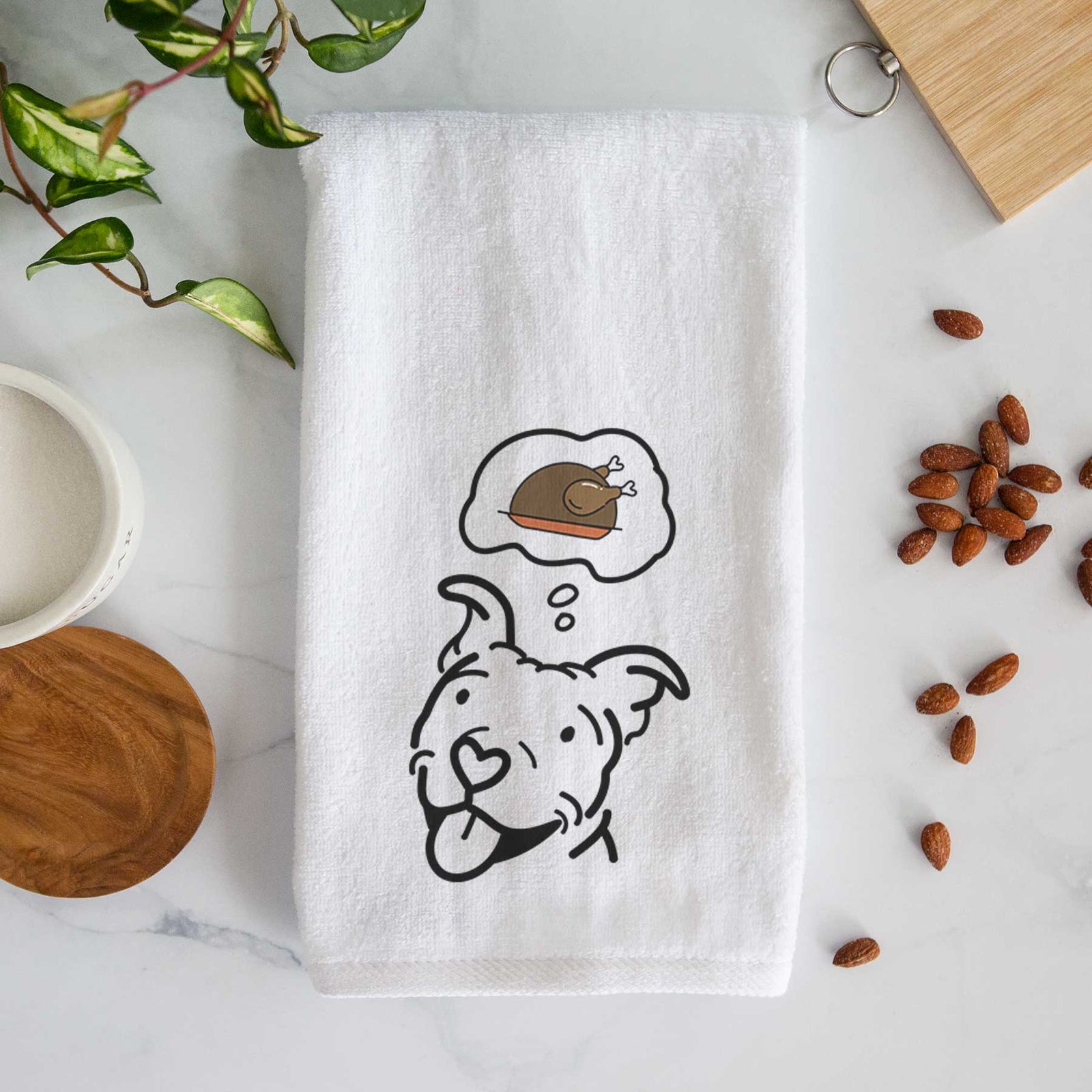 Minimalist line drawing of Arlo the Pitbull with a little turkey on a decorative hand towel