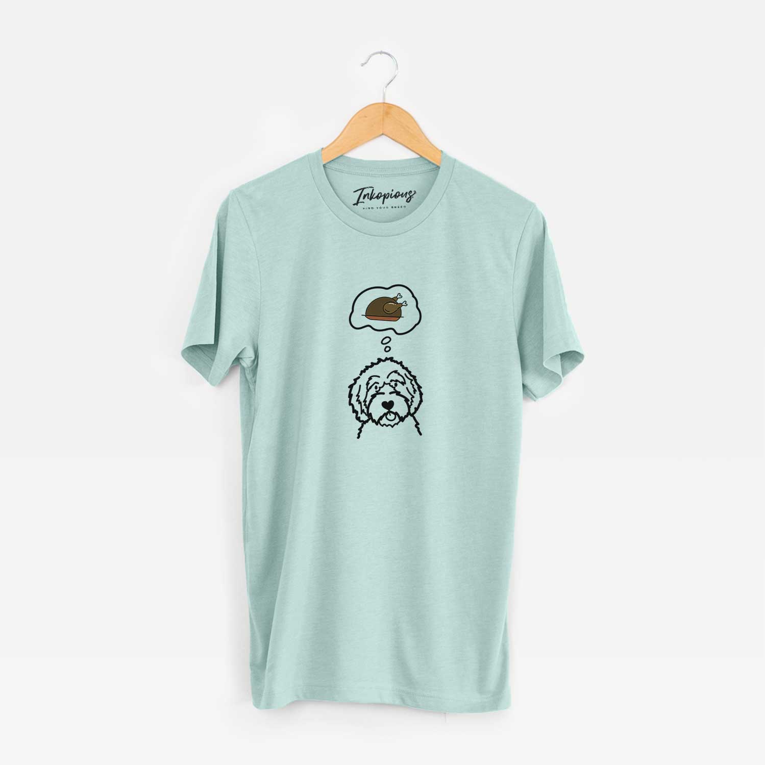 Minimalist line drawing of an Aussiedoodle with a little turkey on a Heather Sage Unisex crewneck