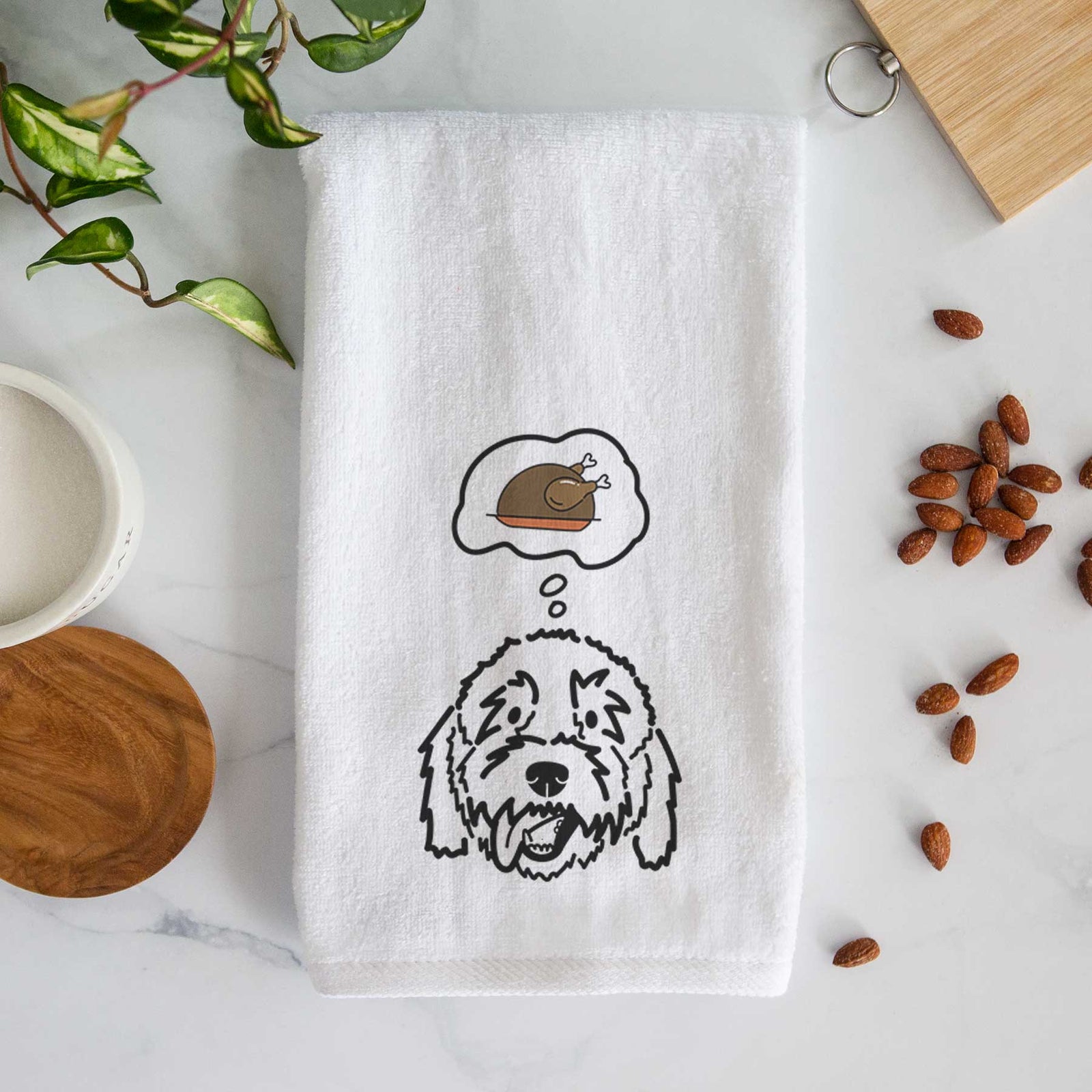 Minimalist line drawing of Barry the Goldendoodle with a little turkey on a decorative hand towel