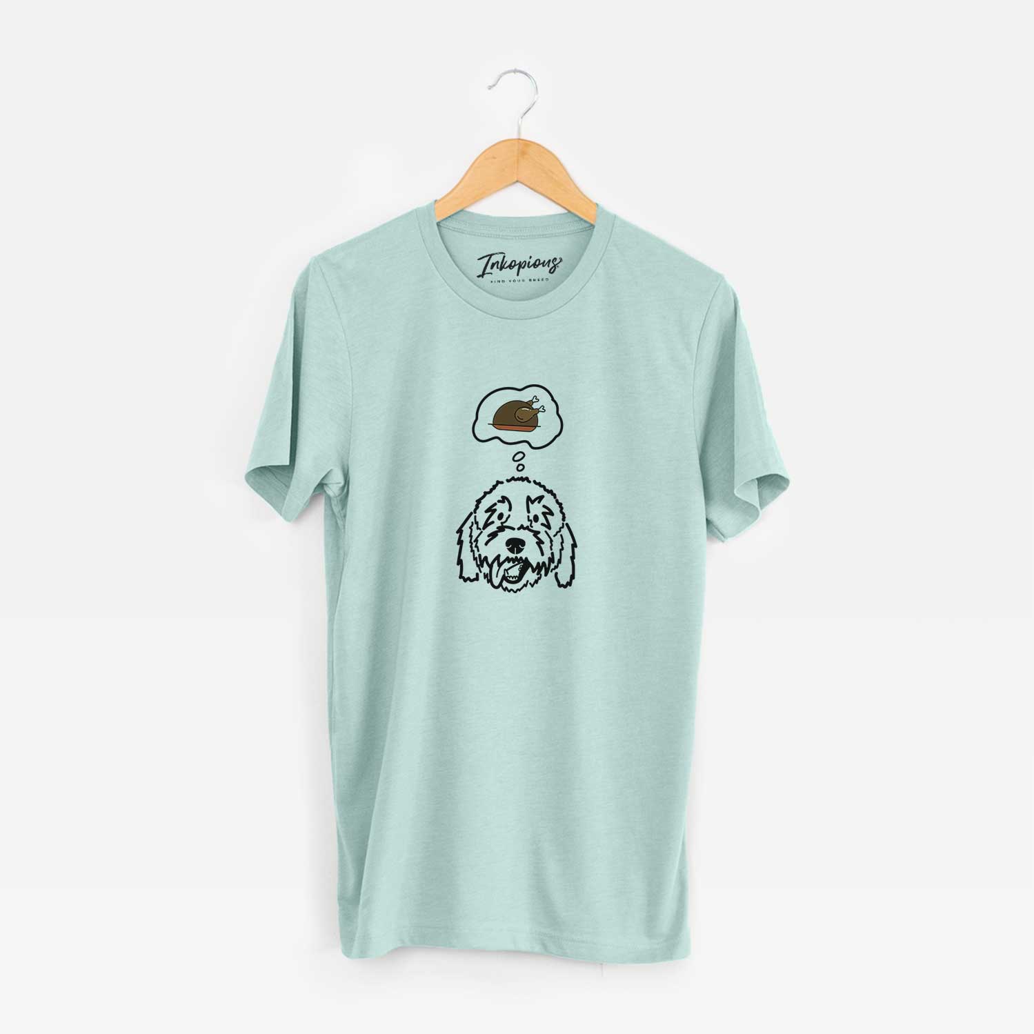 Minimalist line drawing of Barry the Goldendoodle with a little turkey on a Heather Sage Unisex crewneck