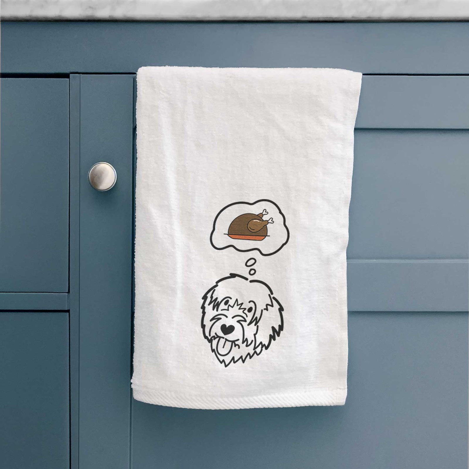 Minimalist line drawing of a Catalan Sheepdog with a little turkey on a decorative hand towel
