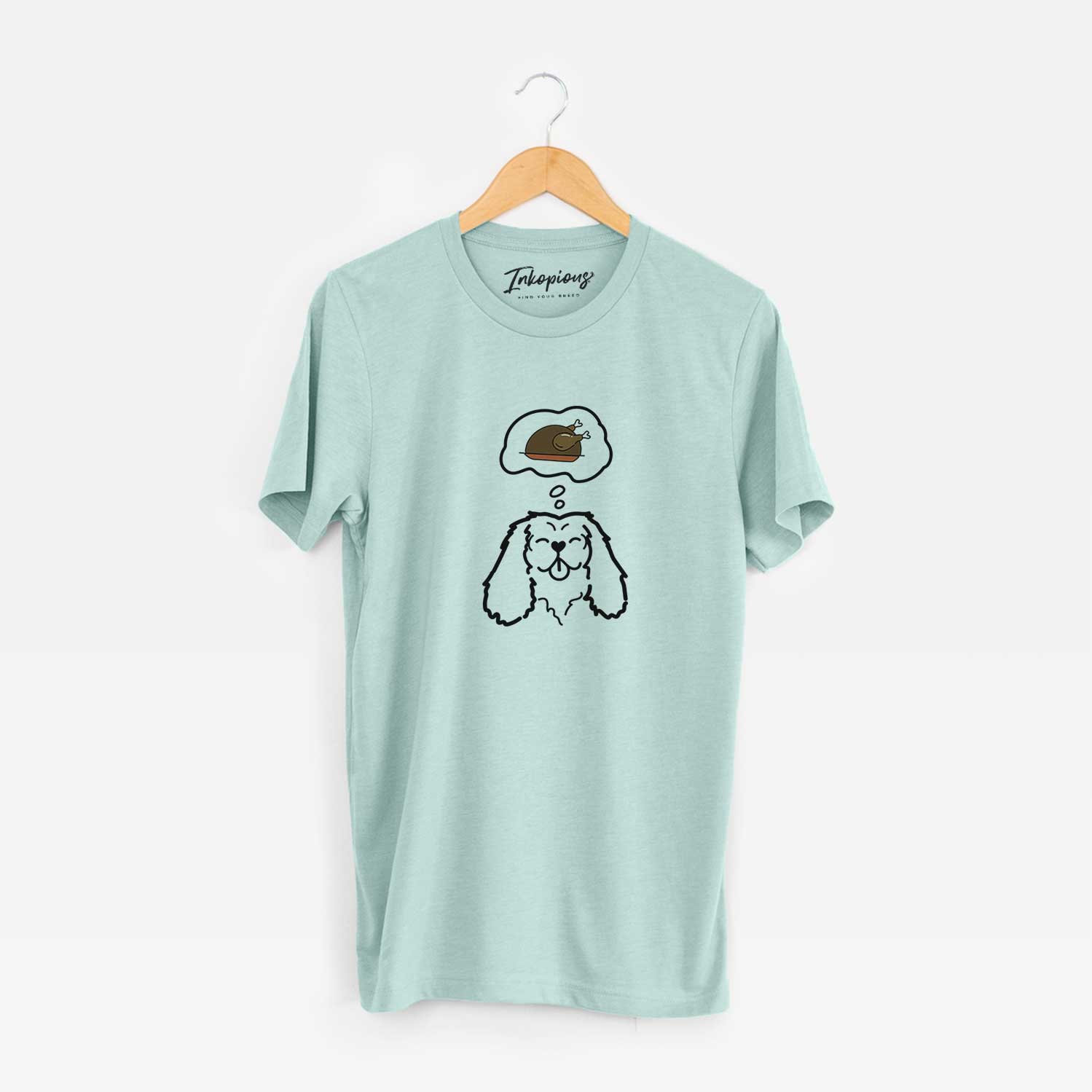 Minimalist line drawing of a Cavalier King Charles Spaniel with a little turkey on a Heather Sage Unisex crewneck