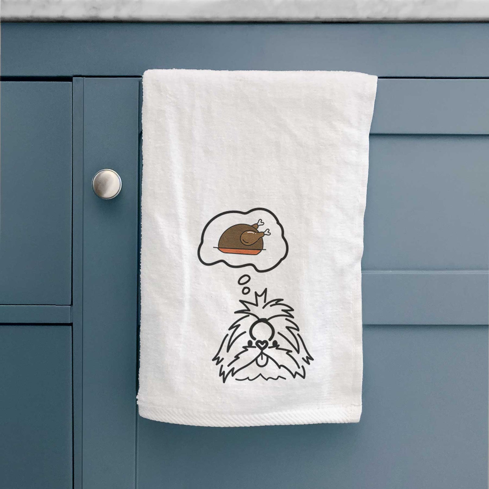 Minimalist line drawing of CoCo the Shih Tzu with a little turkey on a decorative hand towel