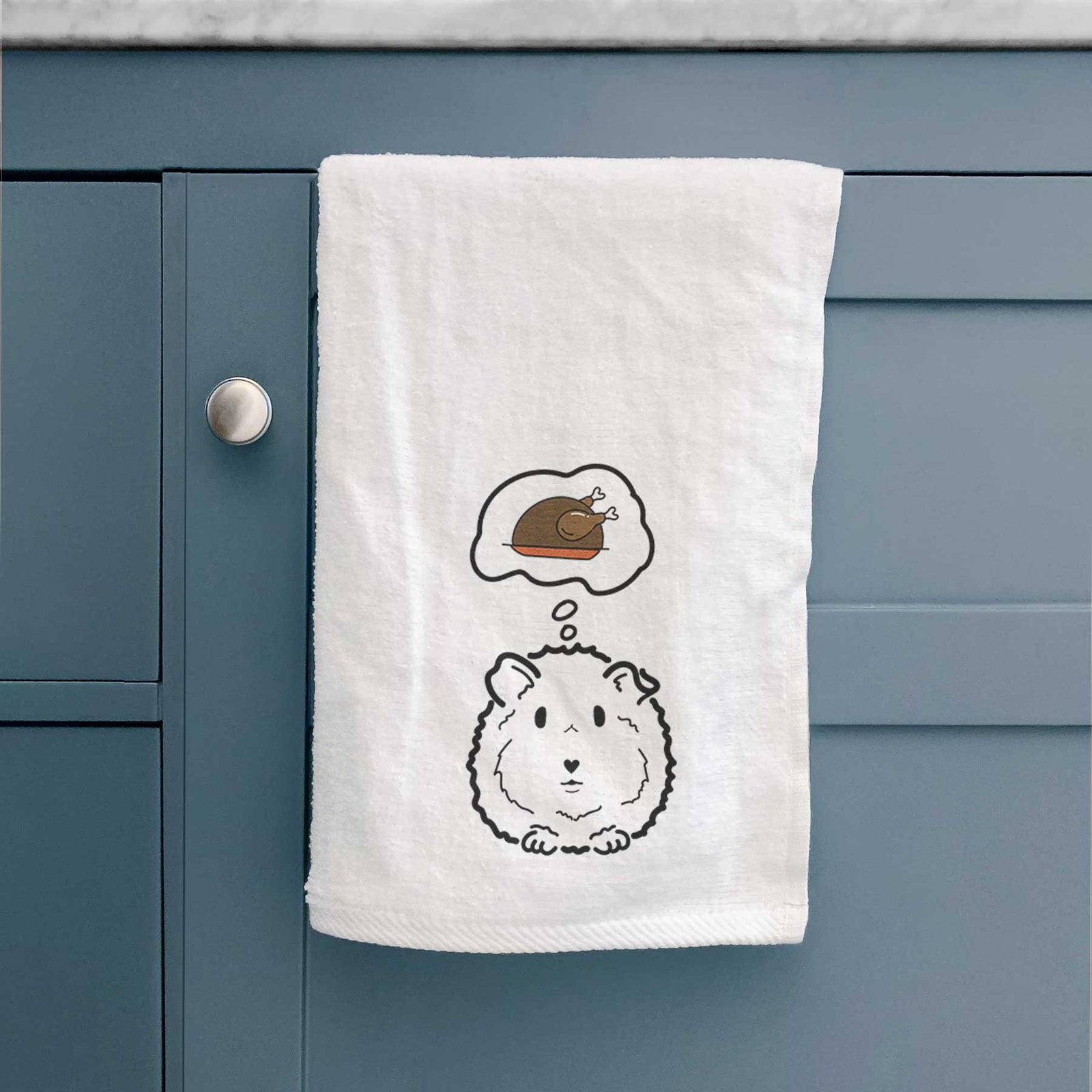 Minimalist line drawing of Duke the Guinea Pig with a little turkey on a decorative hand towel