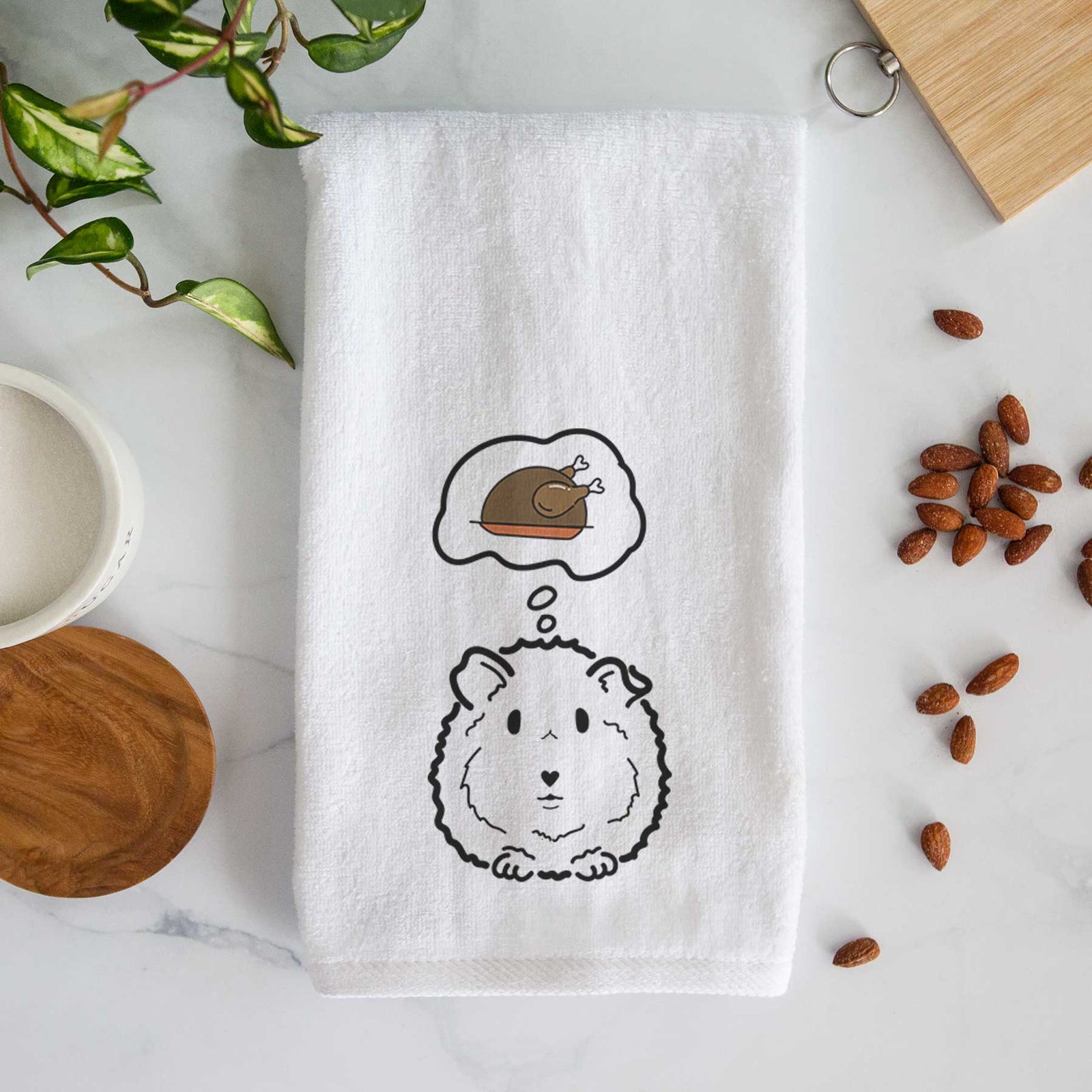 Minimalist line drawing of Duke the Guinea Pig with a little turkey on a decorative hand towel