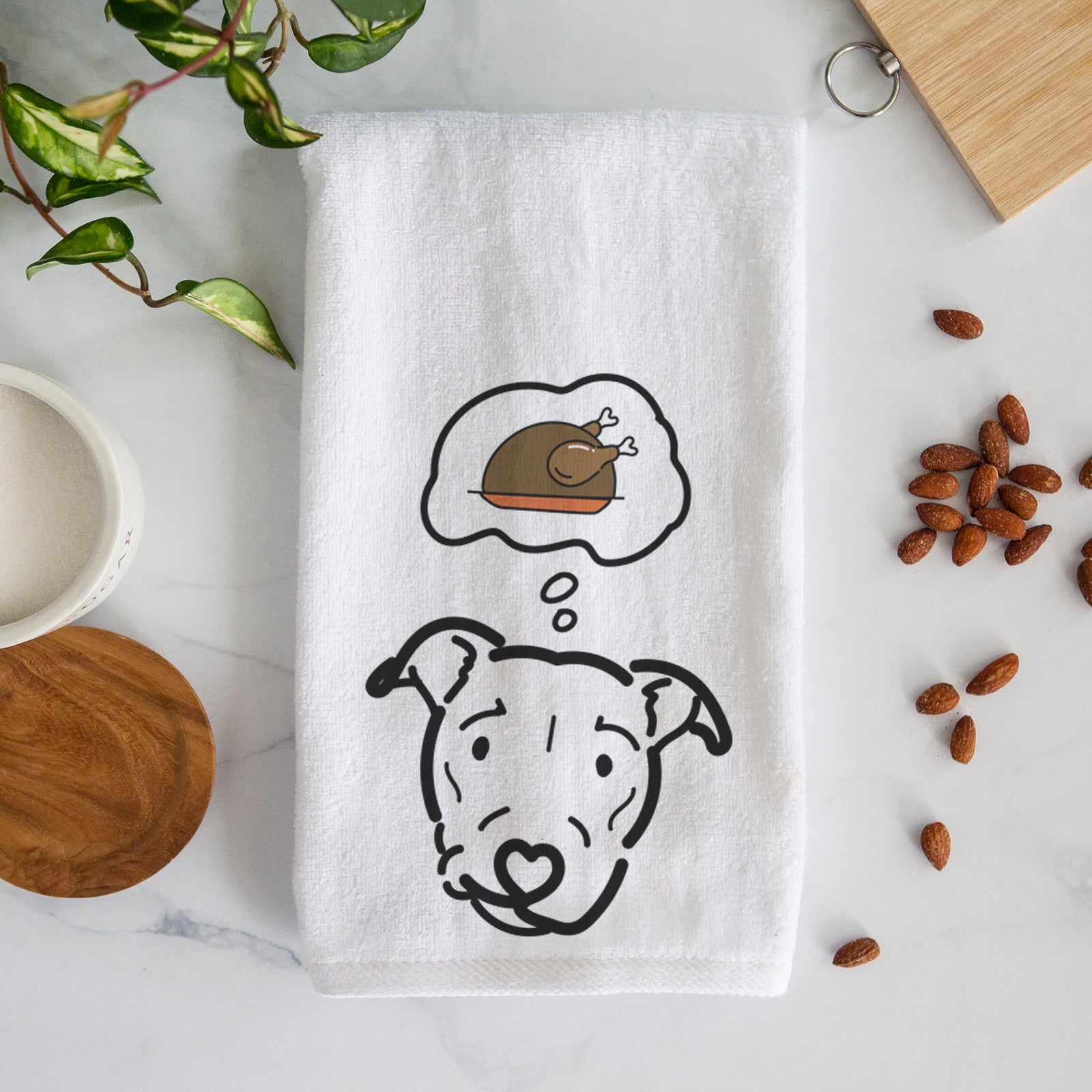 Minimalist line drawing of Ernie the Pitbull Mix with a little turkey on a decorative hand towel