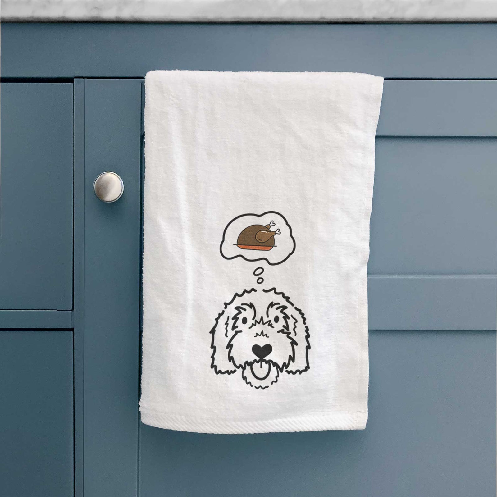 Minimalist line drawing of Gus the Goldendoodle with a little turkey on a decorative hand towel