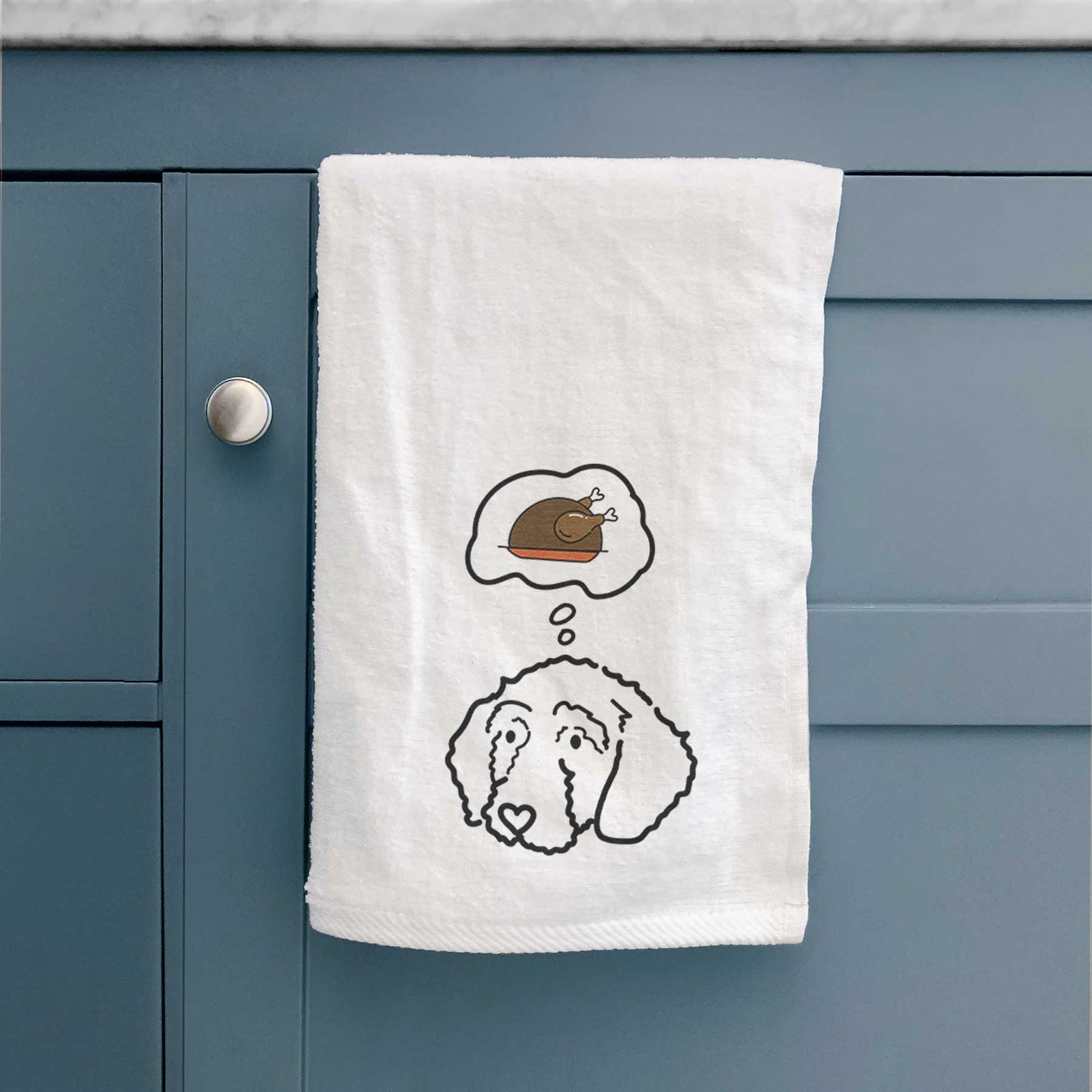 Minimalist line drawing of Hanna the Goldendoodle with a little turkey on a decorative hand towel