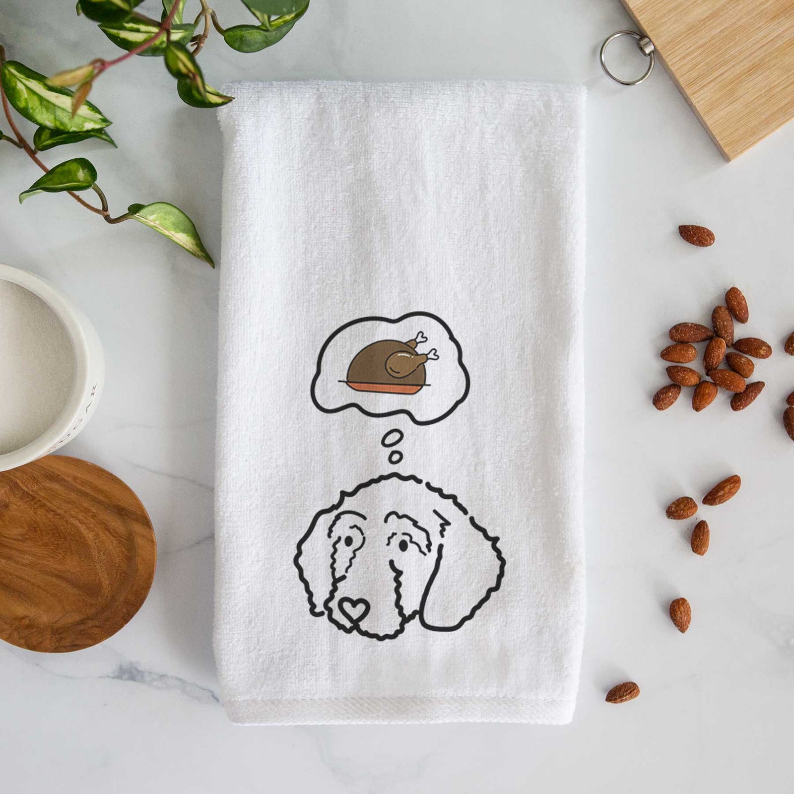 Minimalist line drawing of Hanna the Goldendoodle with a little turkey on a decorative hand towel
