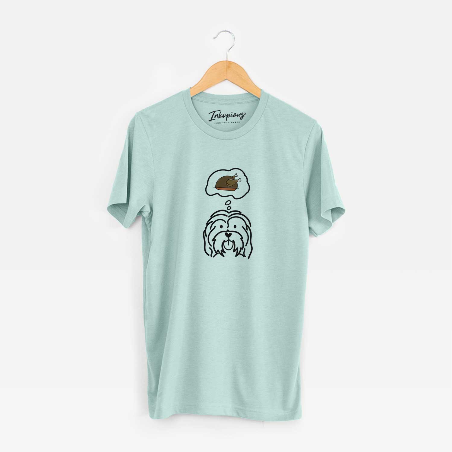 Minimalist line drawing of a Havanese with a little turkey on a Heather Sage Unisex crewneck