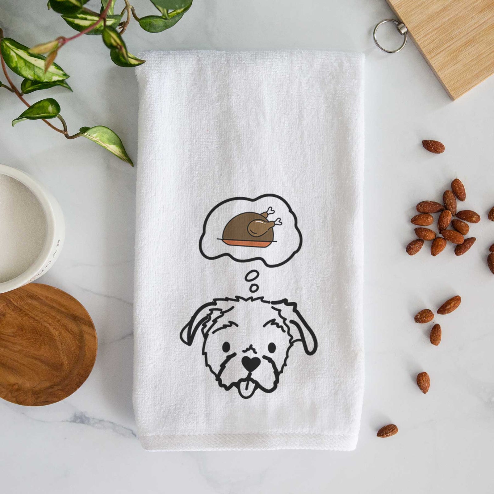 Minimalist line drawing of Koko the Shih Tzu with a little turkey on a decorative hand towel