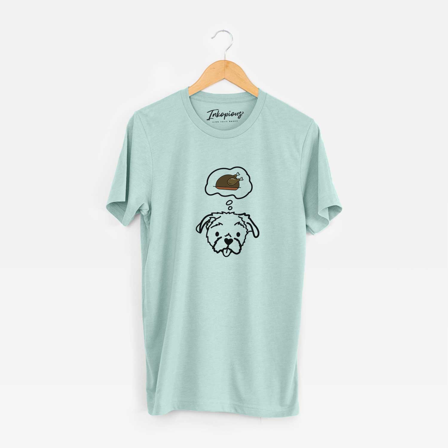 Minimalist line drawing of Koko the Shih Tzu with a little turkey on a Heather Sage Unisex crewneck