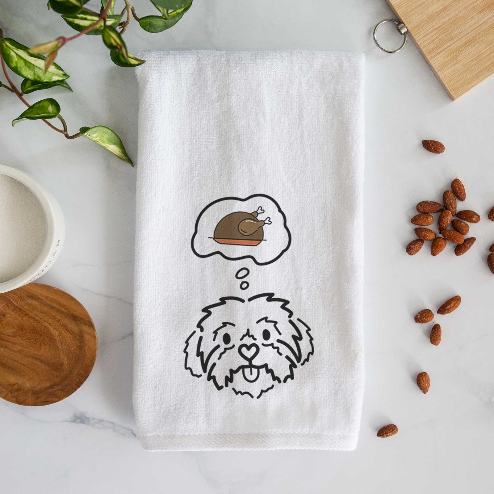 Minimalist line drawing of Leo the Shih Tzu with a little turkey on a decorative hand towel