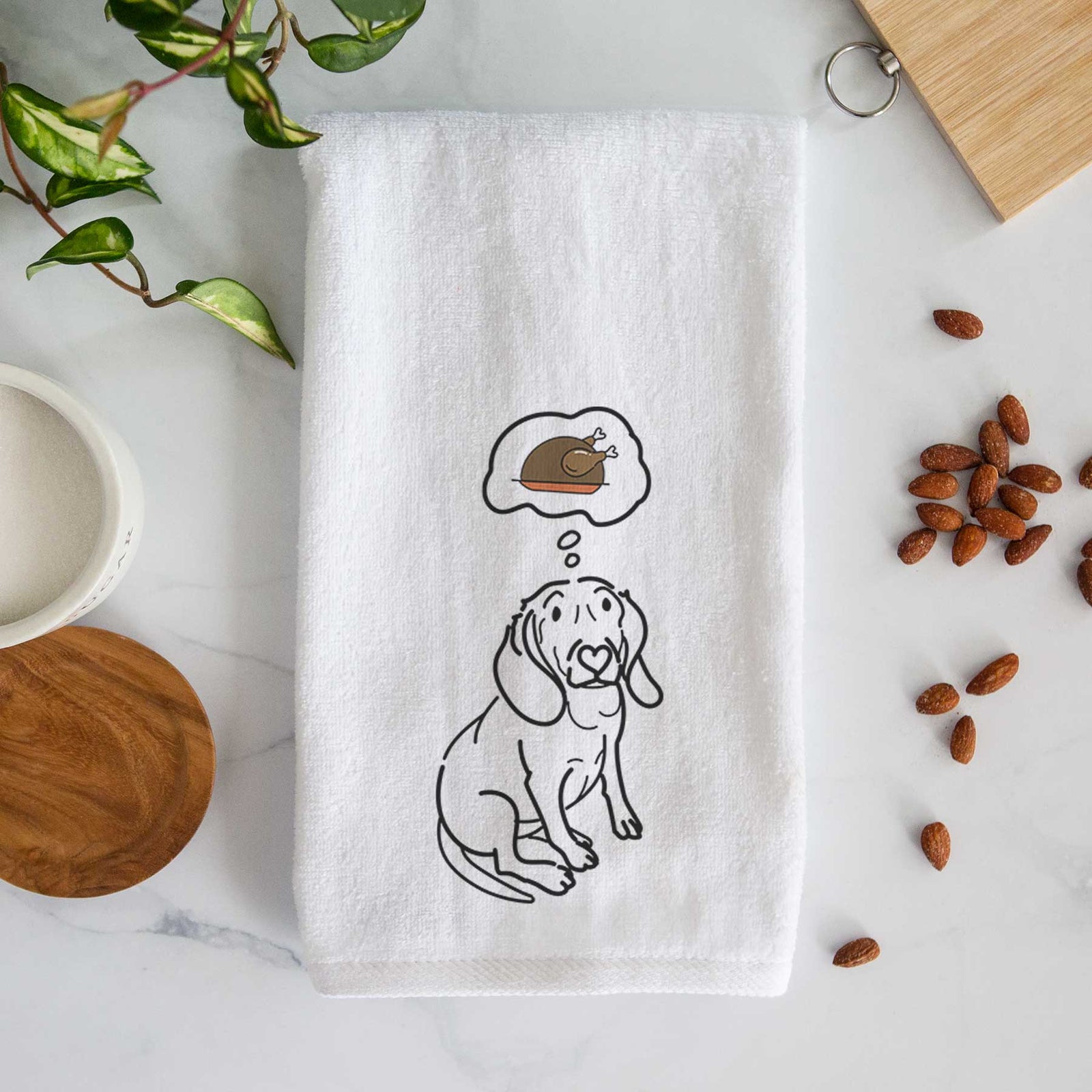 Minimalist line drawing of Lilly the Beagle with a little turkey on a decorative hand towel