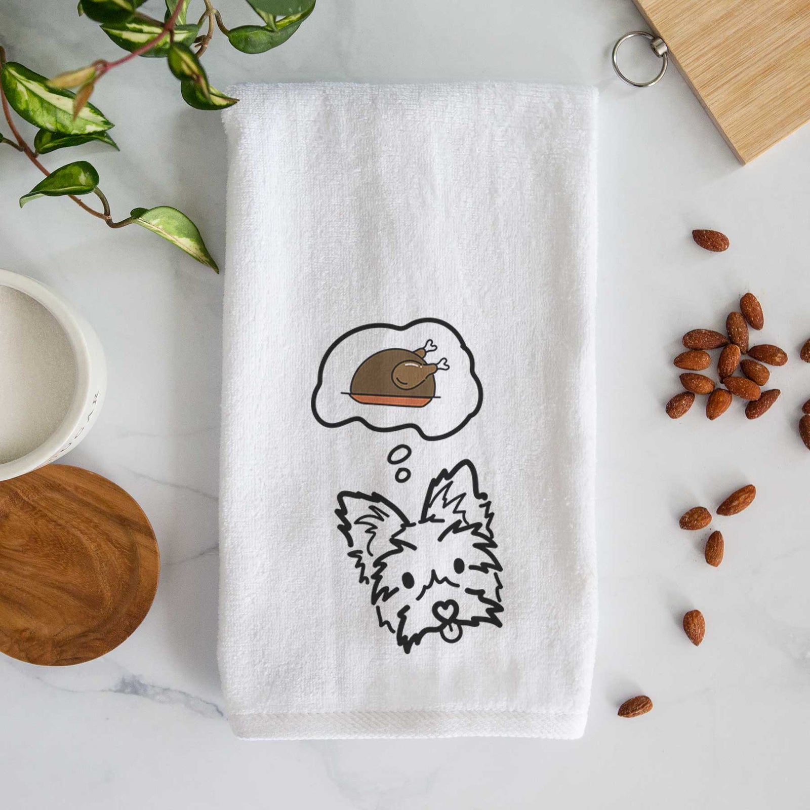 Minimalist line drawing of Luna the Yorkshire Terrier with a little turkey on a decorative hand towel