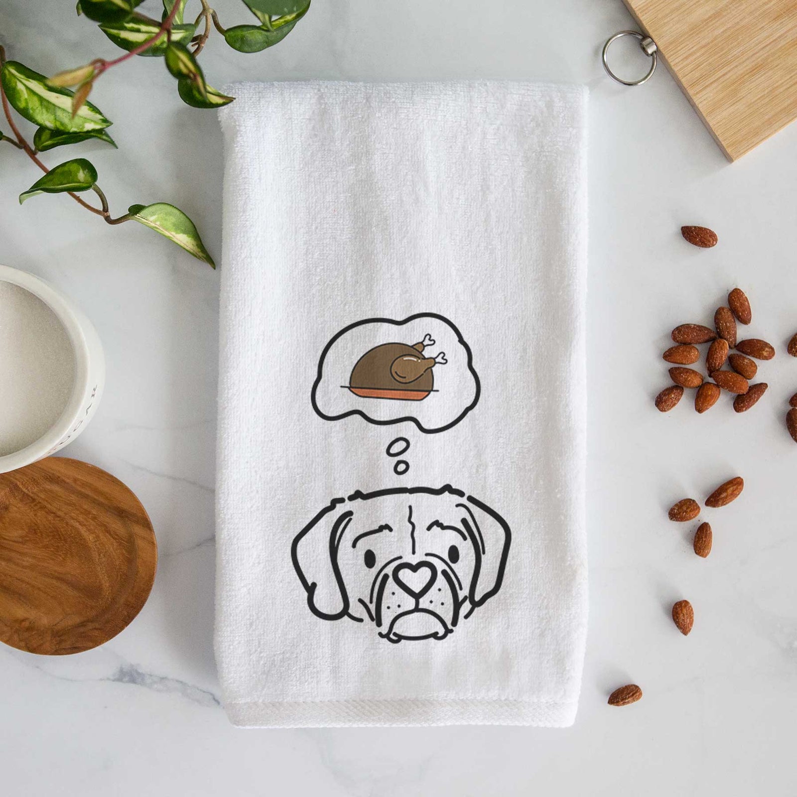 Minimalist line drawing of Mitzi the Puggle with a little turkey on a decorative hand towel