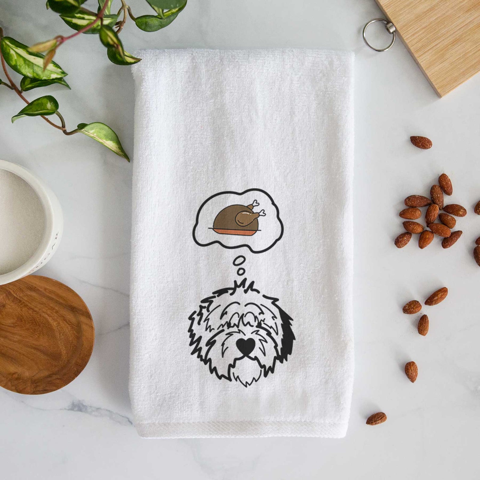 Minimalist line drawing of Penny the Old English Sheepdog with a little turkey on a decorative hand towel