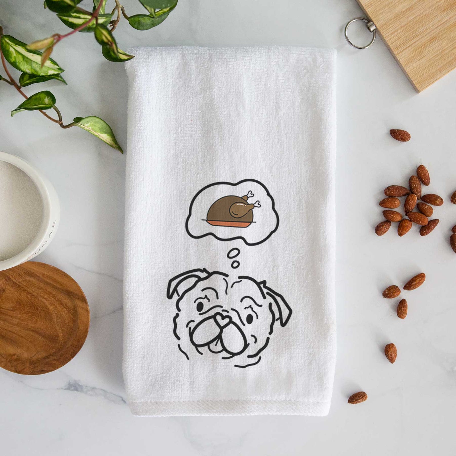 Minimalist line drawing of Pip the Pug with a little turkey on a decorative hand towel
