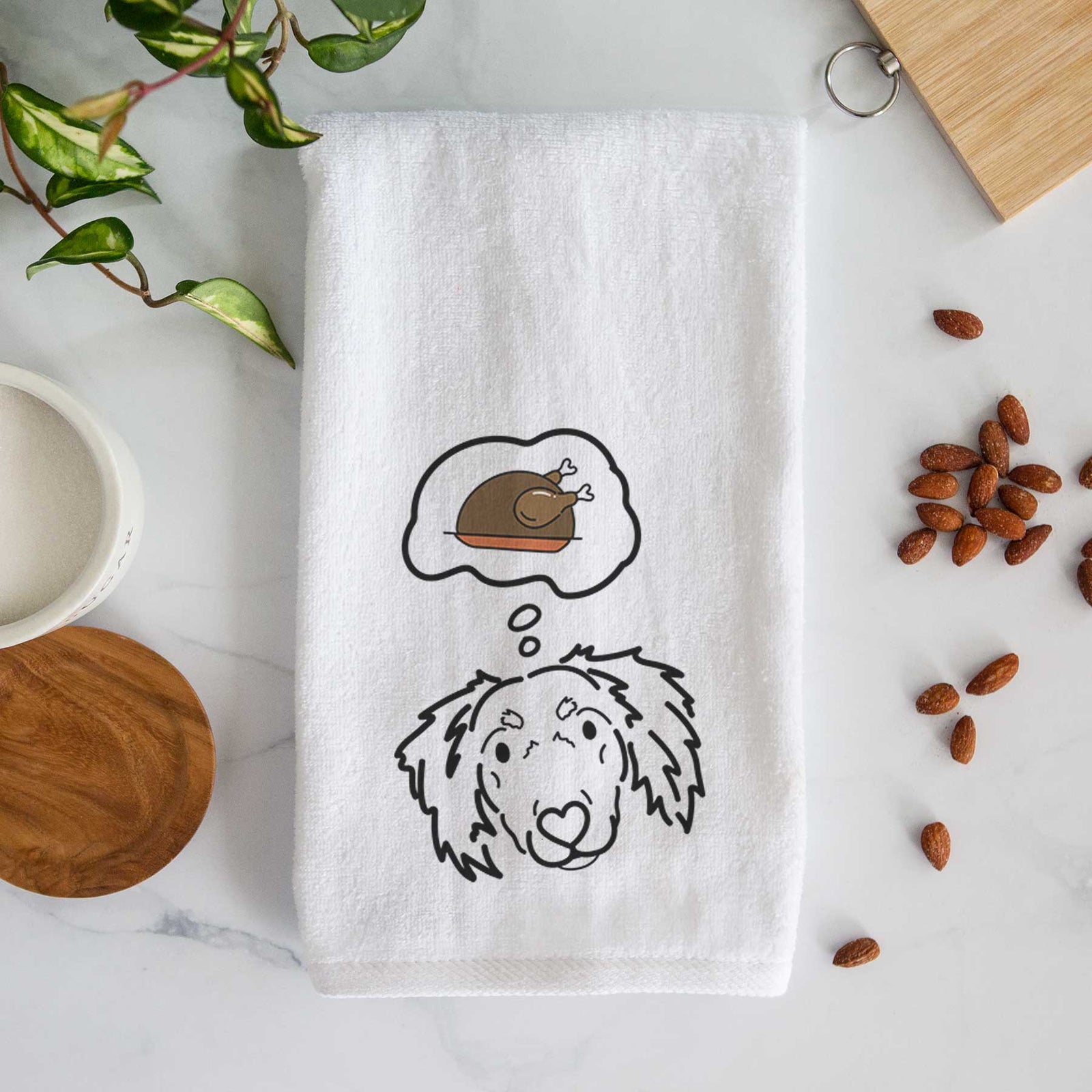 Minimalist line drawing of Tilly the Dachshund Mix with a little turkey on a decorative hand towel