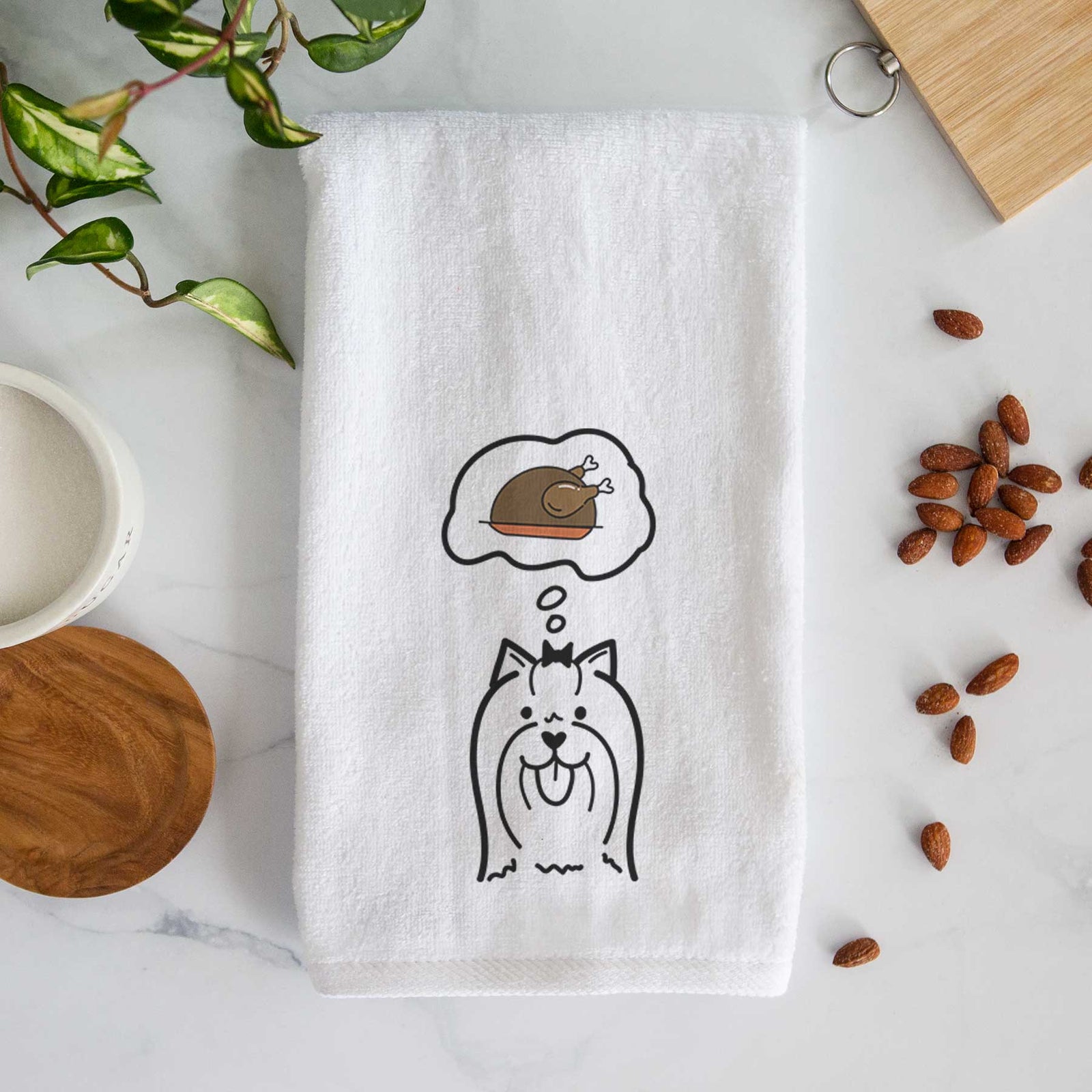 Minimalist line drawing of a Yorkshire Terrier with a little turkey on a decorative hand towel