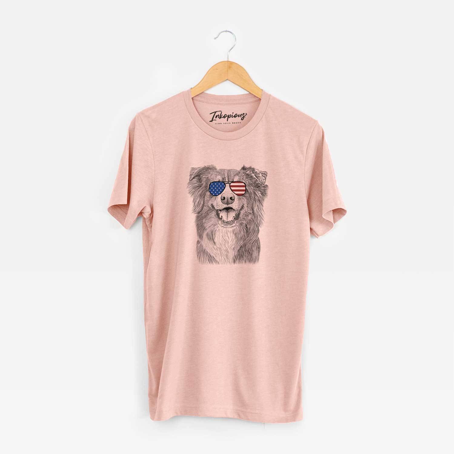Hand-drawn sketch of Aussie Parker the Australian Shepherd wearing American flag sunglasses on a Peach Unisex crewneck