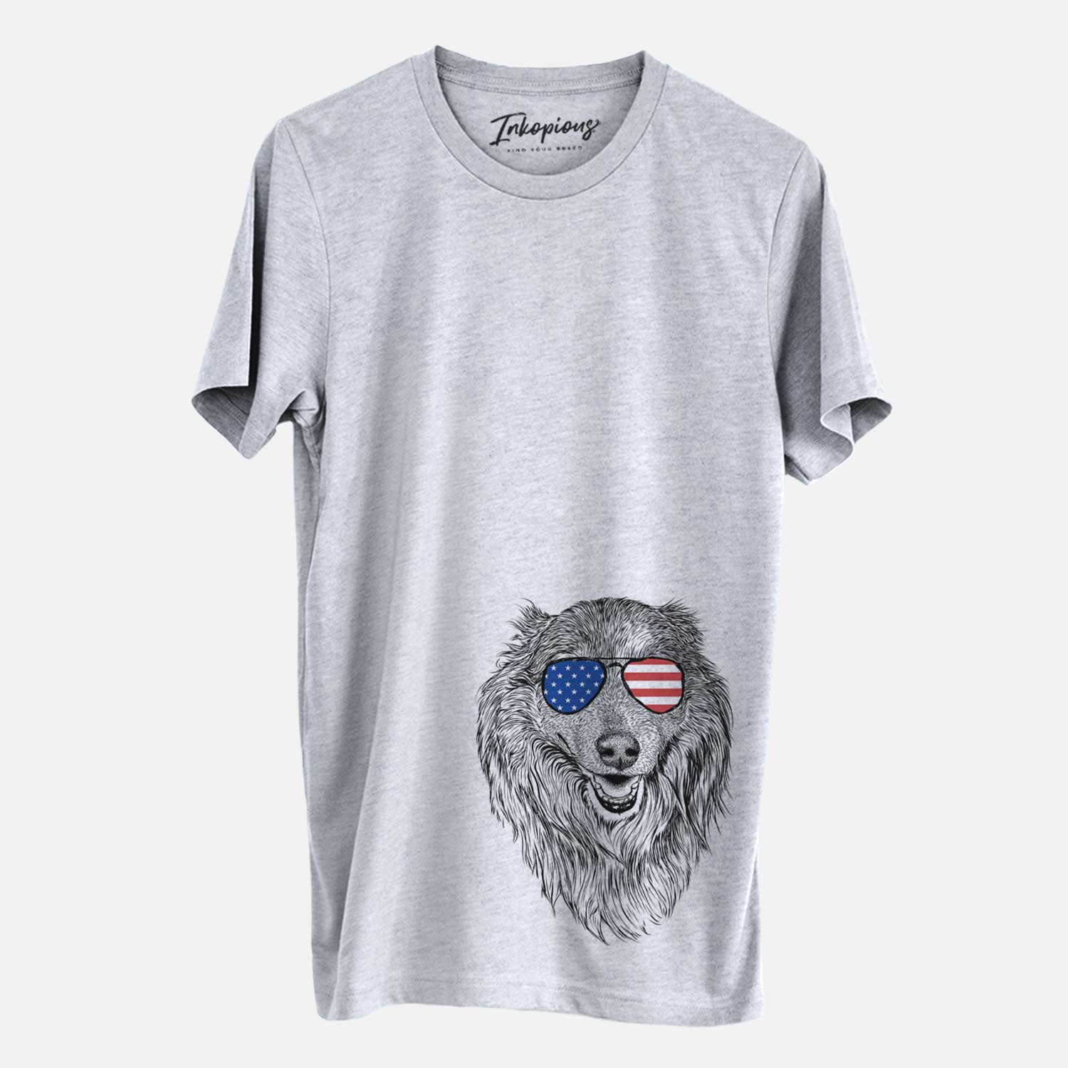 Hand-drawn sketch of Addie the Collie Mix wearing American flag sunglasses on a Grey Unisex crewneck