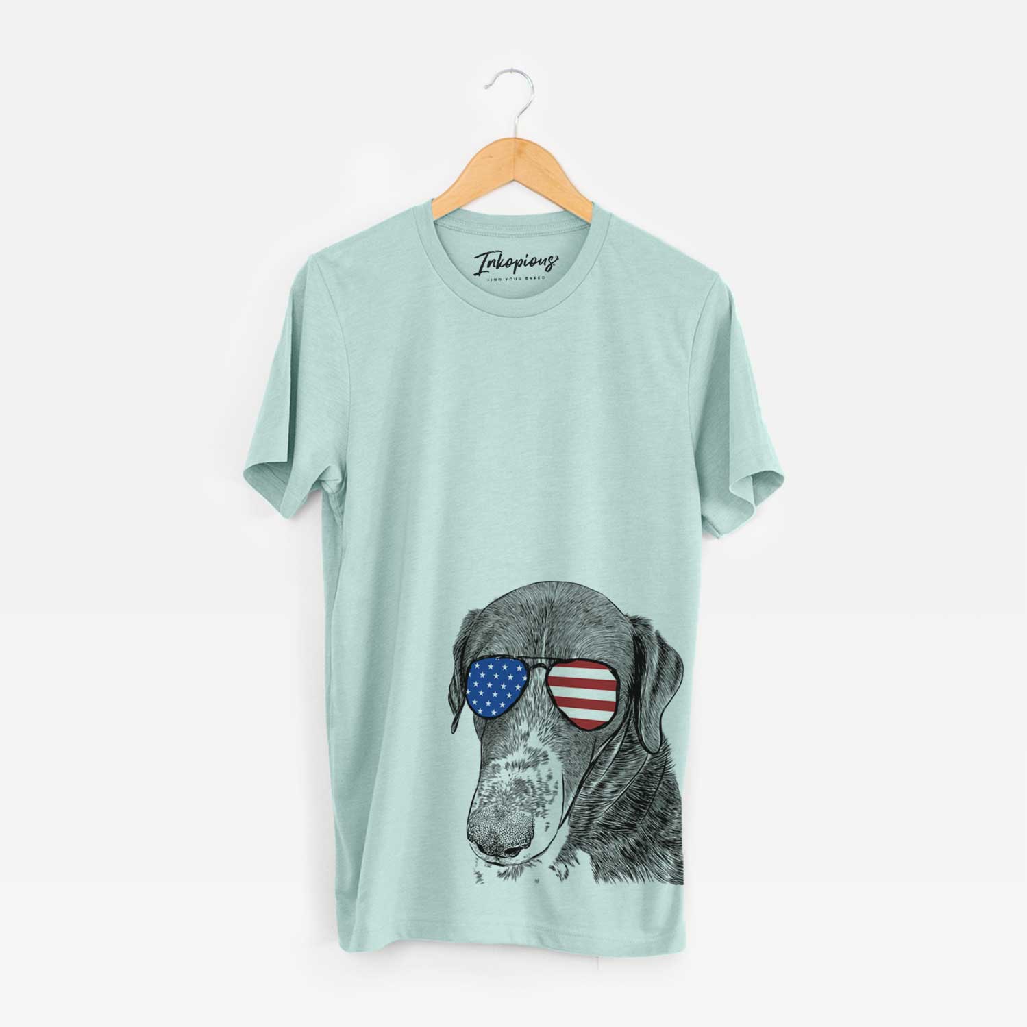 Hand-drawn sketch of Angel Orion the Mixed Breed wearing American flag sunglasses on a Heather Sage Unisex crewneck