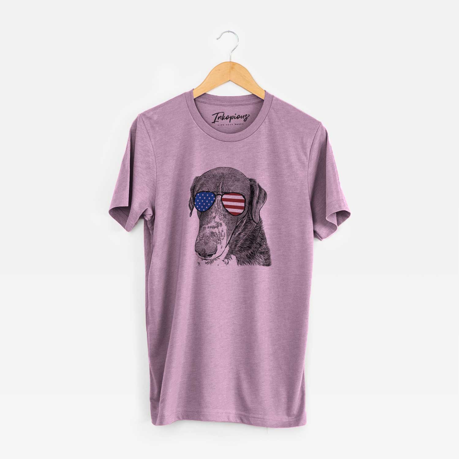 Hand-drawn sketch of Angel Orion the Mixed Breed wearing American flag sunglasses on an Orchid Unisex crewneck