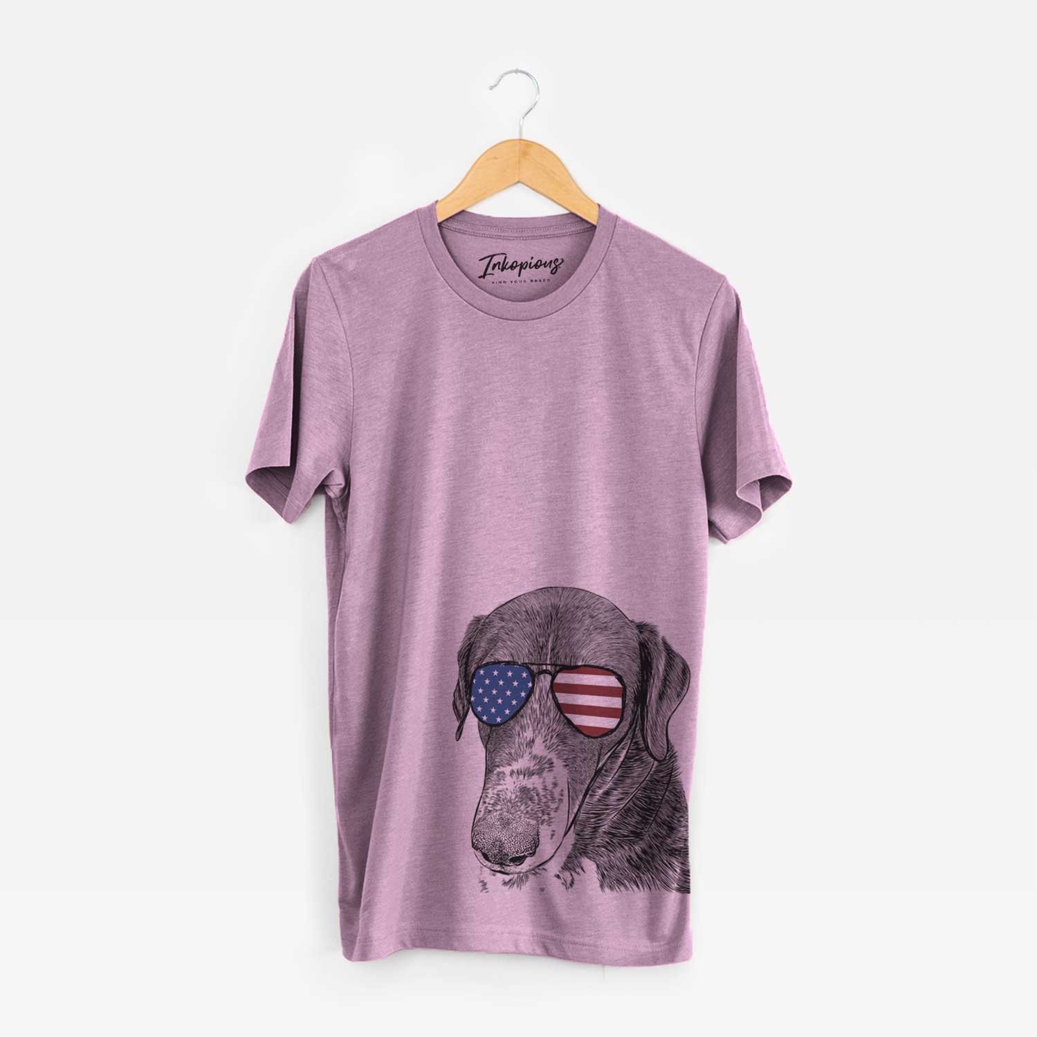 Hand-drawn sketch of Angel Orion the Mixed Breed wearing American flag sunglasses on an Orchid Unisex crewneck