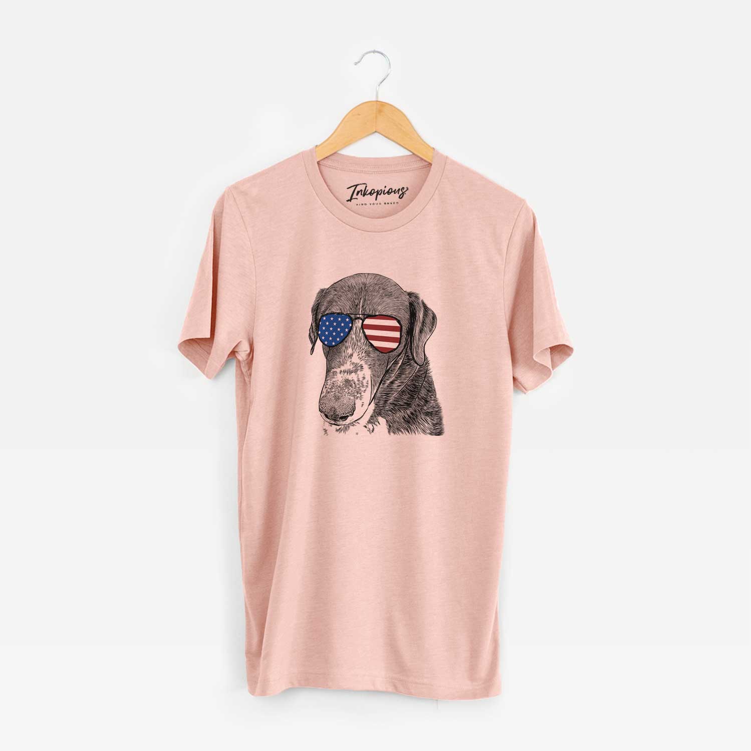 Hand-drawn sketch of Angel Orion the Mixed Breed wearing American flag sunglasses on a Peach Unisex crewneck
