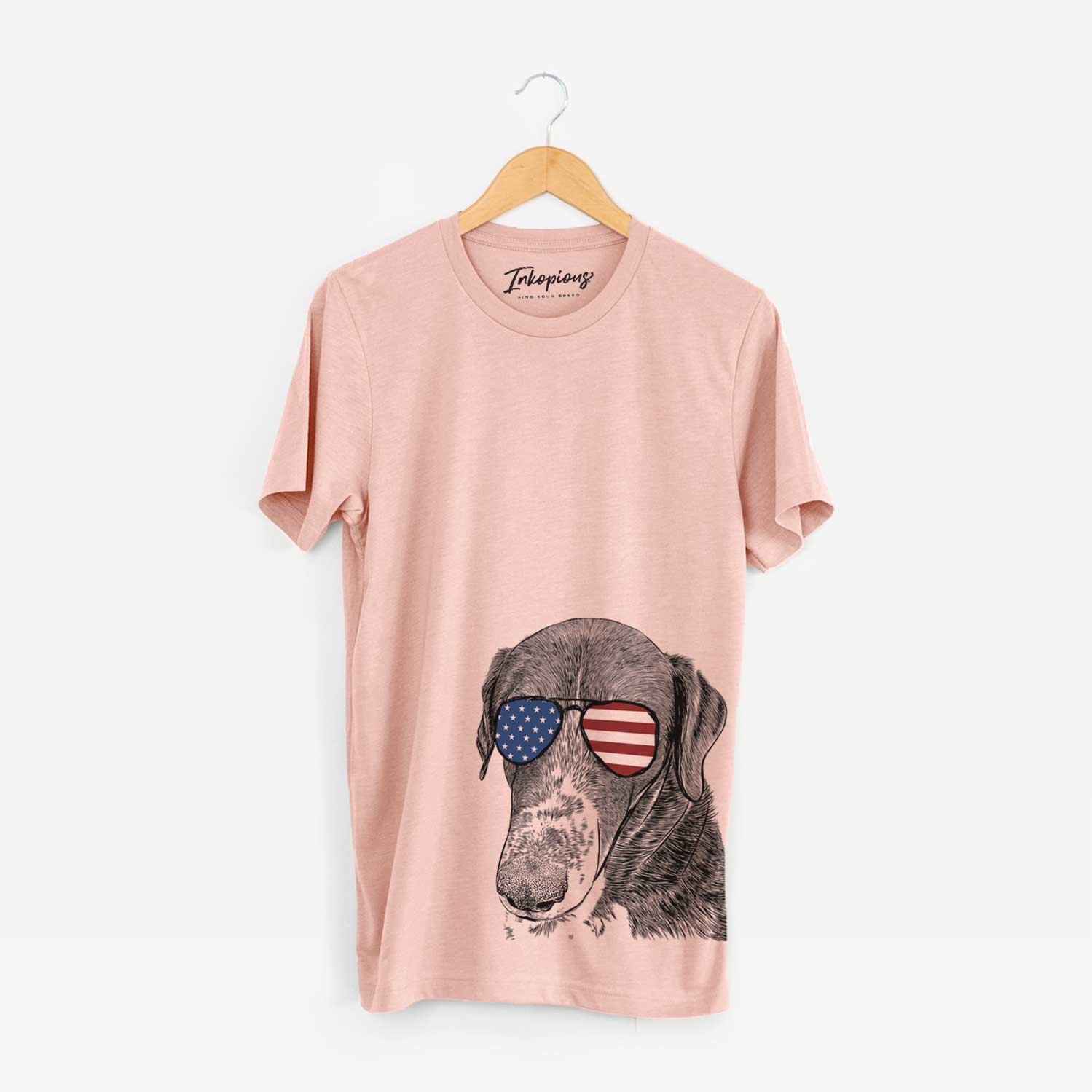 Hand-drawn sketch of Angel Orion the Mixed Breed wearing American flag sunglasses on a Peach Unisex crewneck