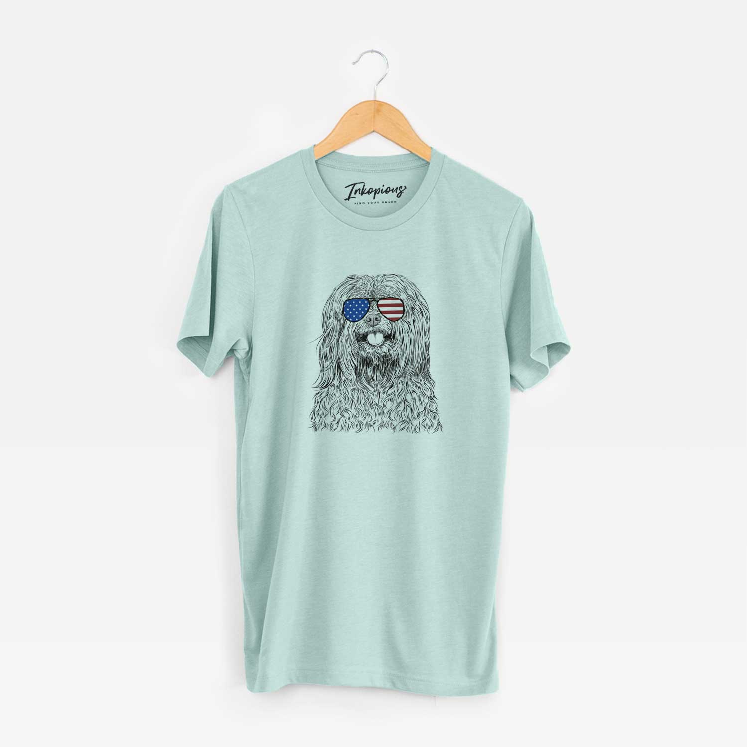 Hand-drawn sketch of Annie the Mixed Breed wearing American flag sunglasses on a Heather Sage Unisex crewneck