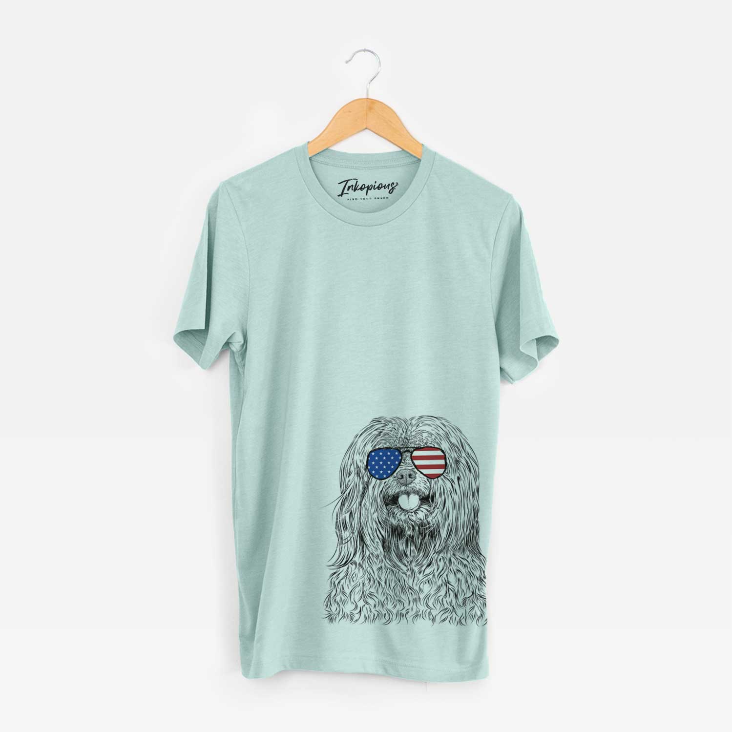 Hand-drawn sketch of Annie the Mixed Breed wearing American flag sunglasses on a Heather Sage Unisex crewneck