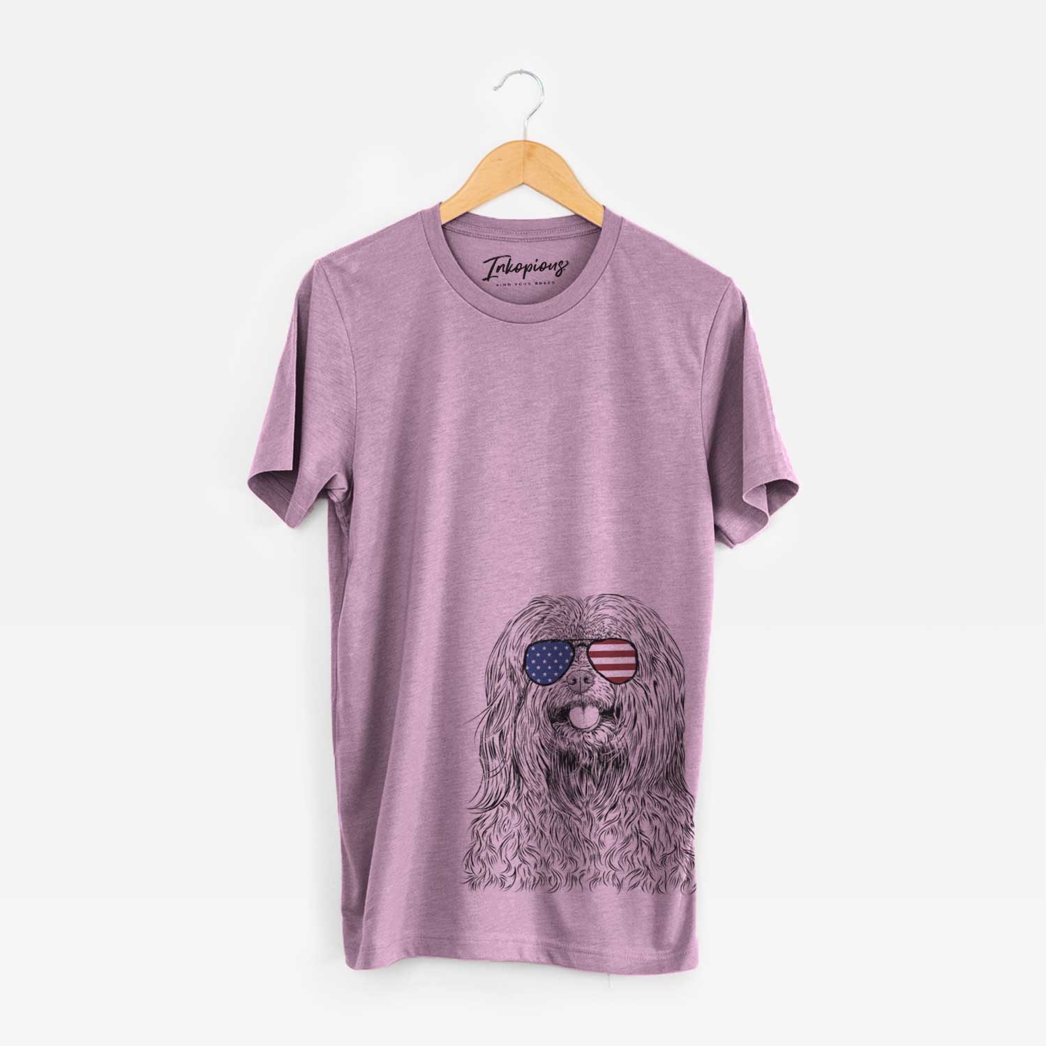 Hand-drawn sketch of Annie the Mixed Breed wearing American flag sunglasses on an Orchid Unisex crewneck