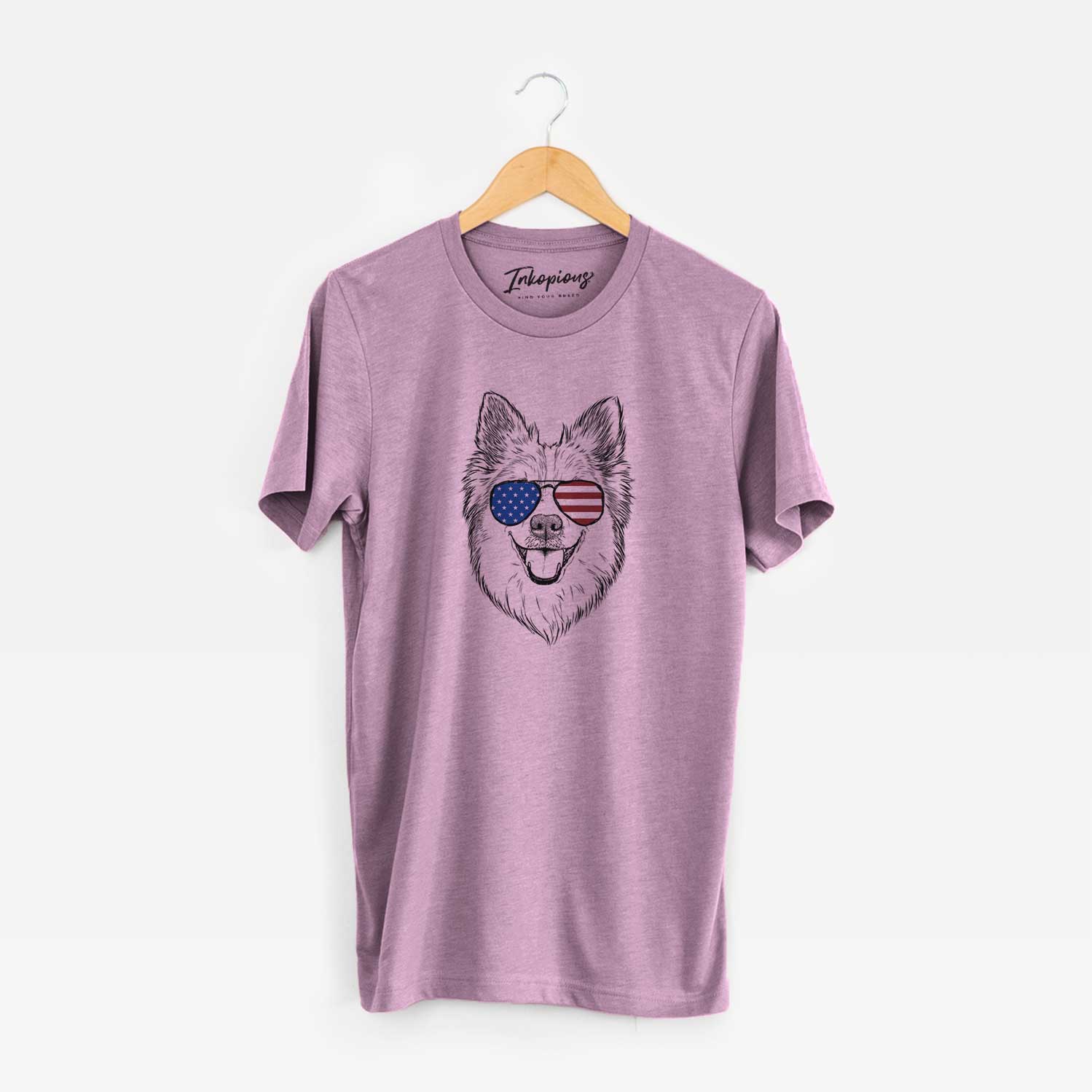 Hand-drawn sketch of Ari the Icelandic Sheepdog wearing American flag sunglasses on an Orchid Unisex crewneck