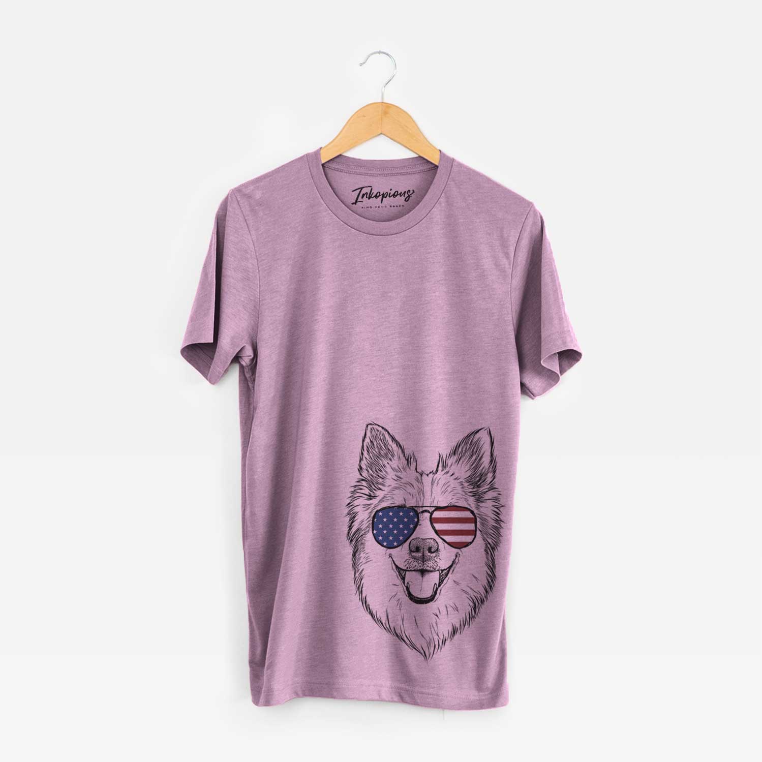 Hand-drawn sketch of Ari the Icelandic Sheepdog wearing American flag sunglasses on an Orchid Unisex crewneck