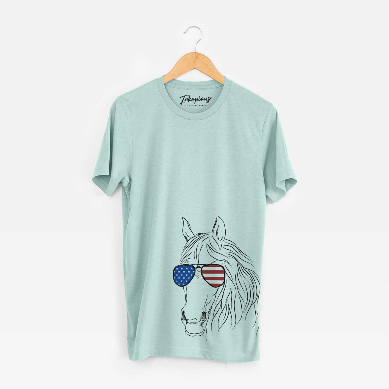 Hand-drawn sketch of Aria the Horse wearing American flag sunglasses on a Heather Sage Unisex crewneck
