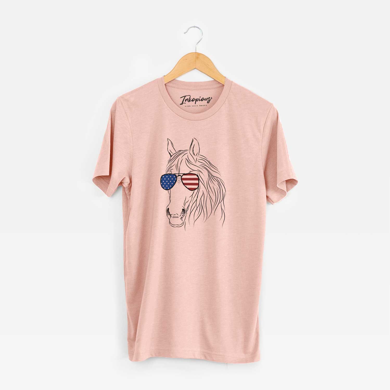 Hand-drawn sketch of Aria the Horse wearing American flag sunglasses on a Peach Unisex crewneck