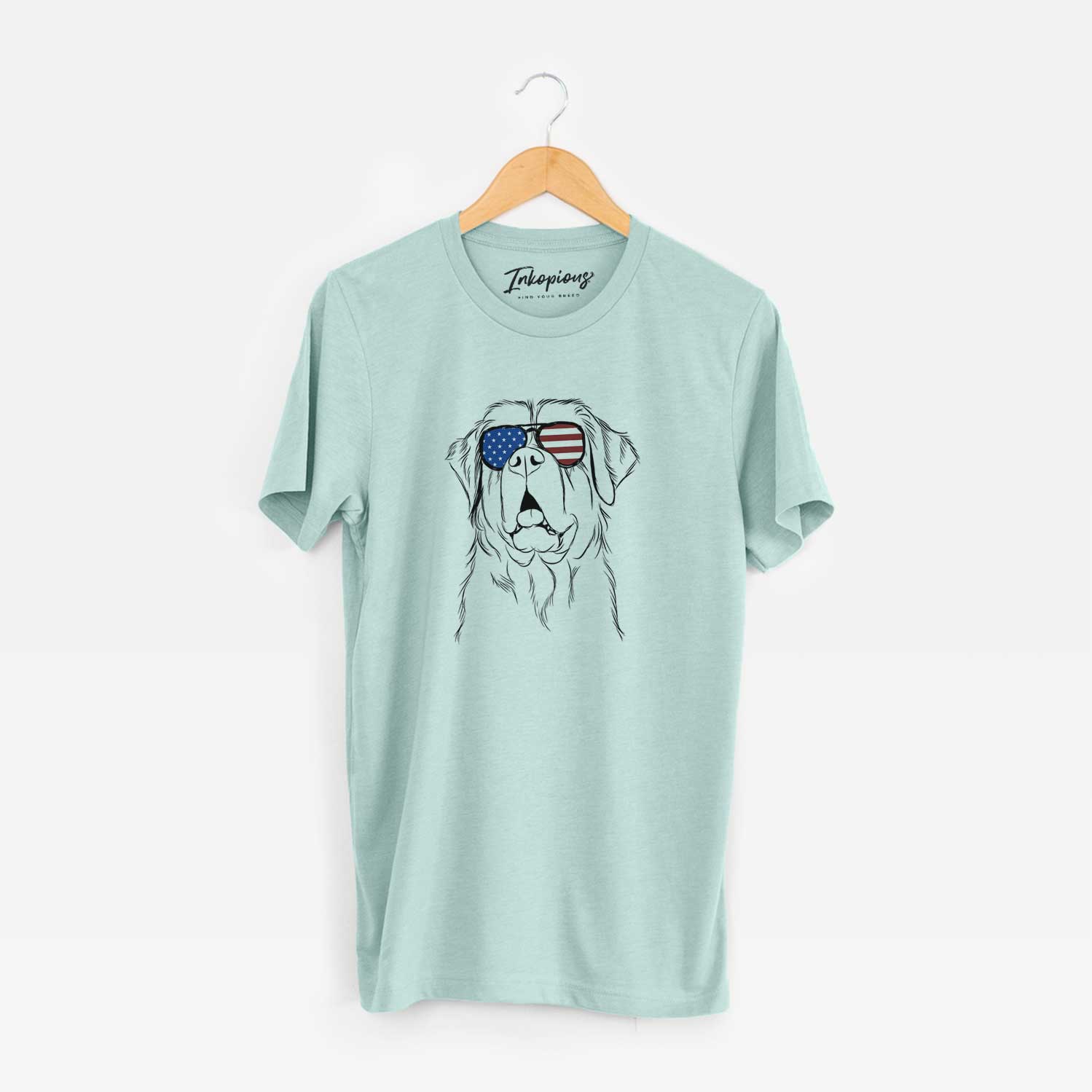 Hand-drawn sketch of Atlas the Saint Bernard wearing American flag sunglasses on a Heather Sage Unisex crewneck