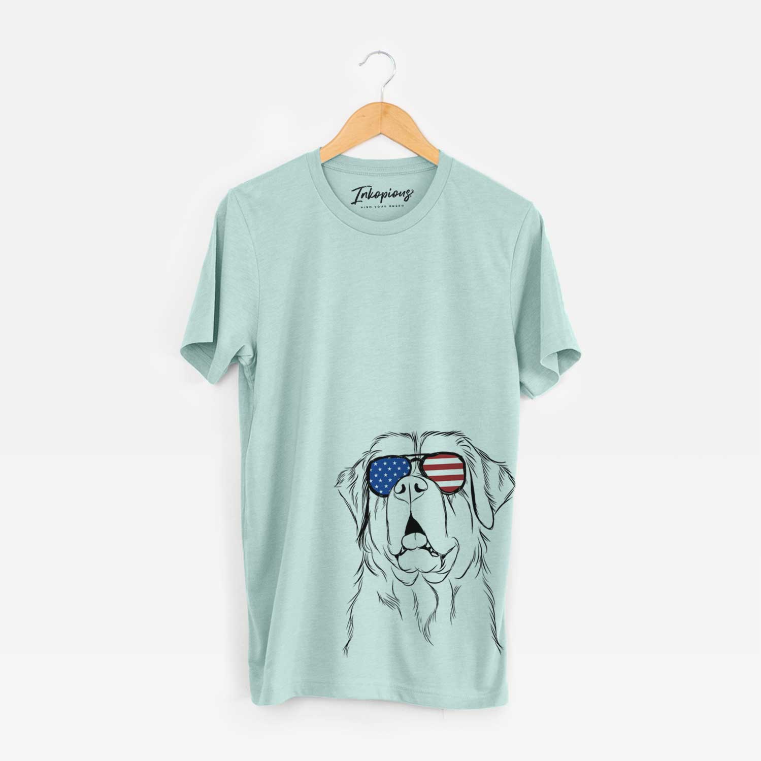 Hand-drawn sketch of Atlas the Saint Bernard wearing American flag sunglasses on a Heather Sage Unisex crewneck