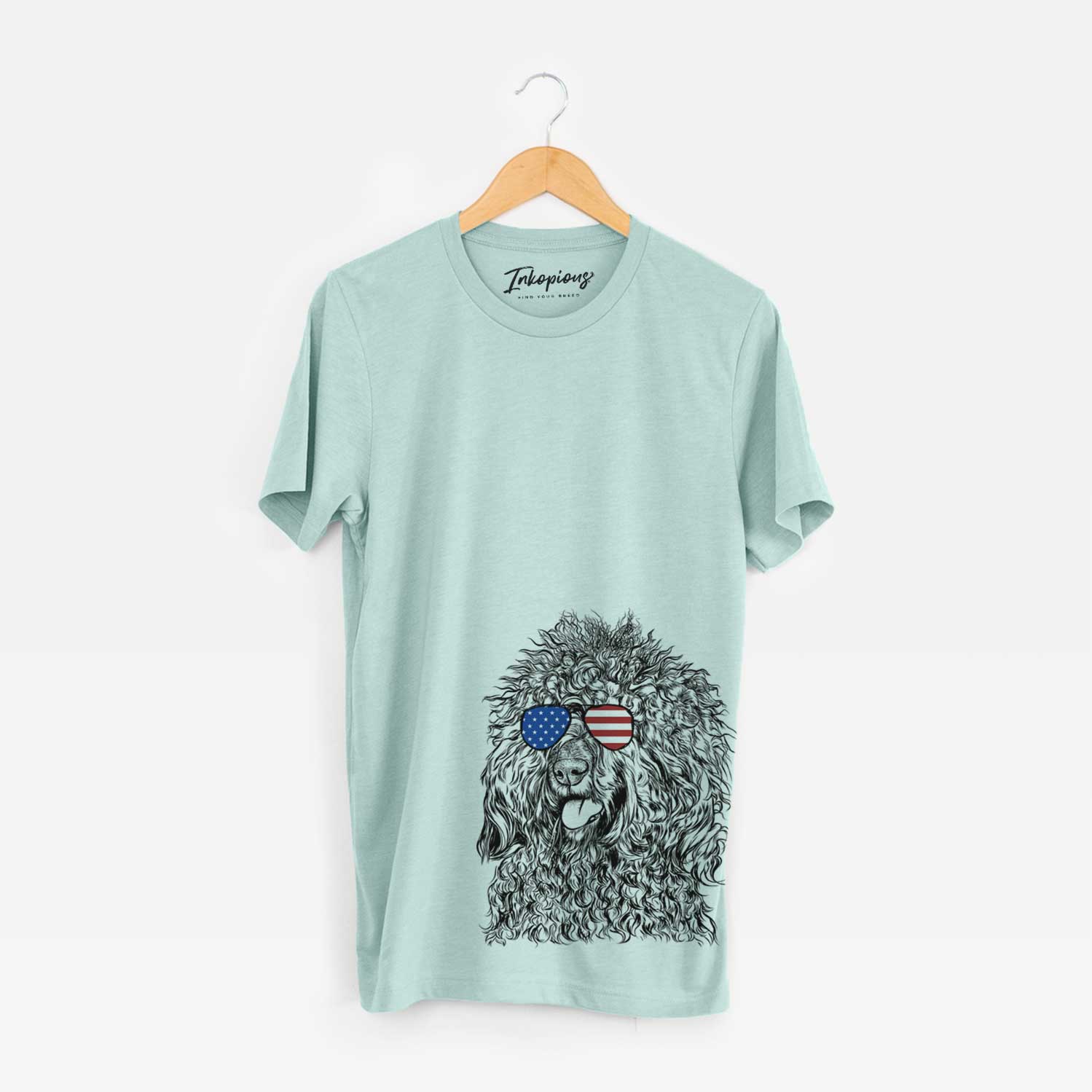 Hand-drawn sketch of Babs the Barbet wearing American flag sunglasses on a Heather Sage Unisex crewneck