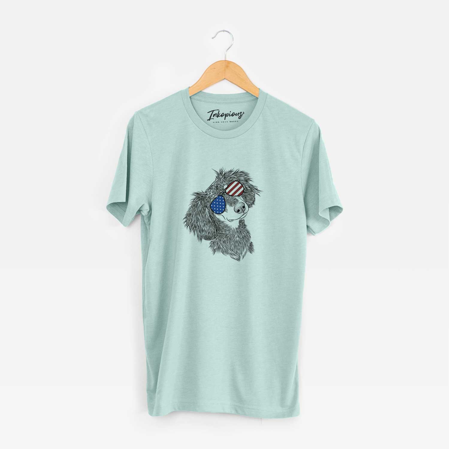 Hand-drawn sketch of Bailey the Long Haired Dachshund wearing American flag sunglasses on a Heather Sage Unisex crewneck
