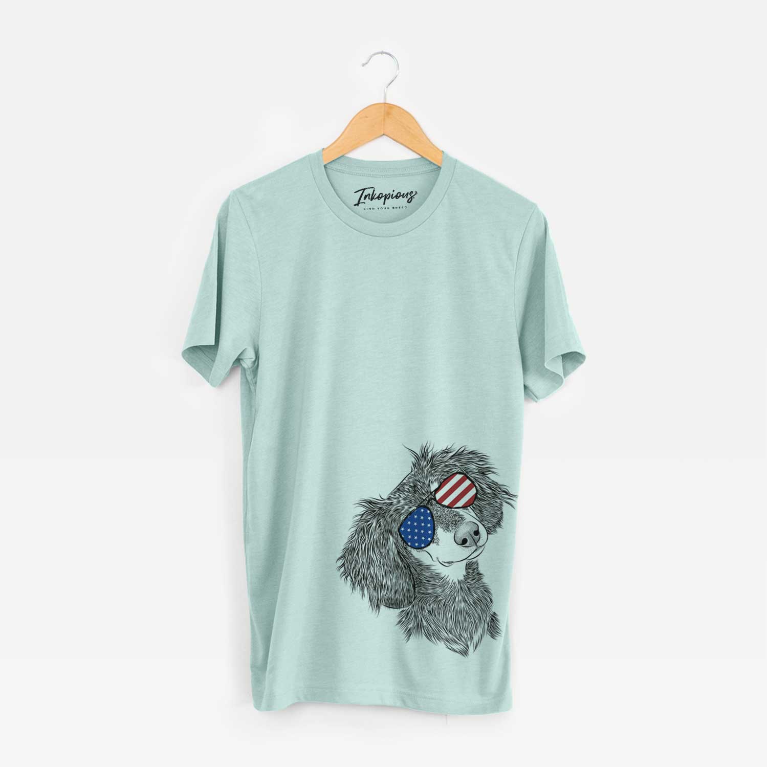 Hand-drawn sketch of Bailey the Long Haired Dachshund wearing American flag sunglasses on a Heather Sage Unisex crewneck