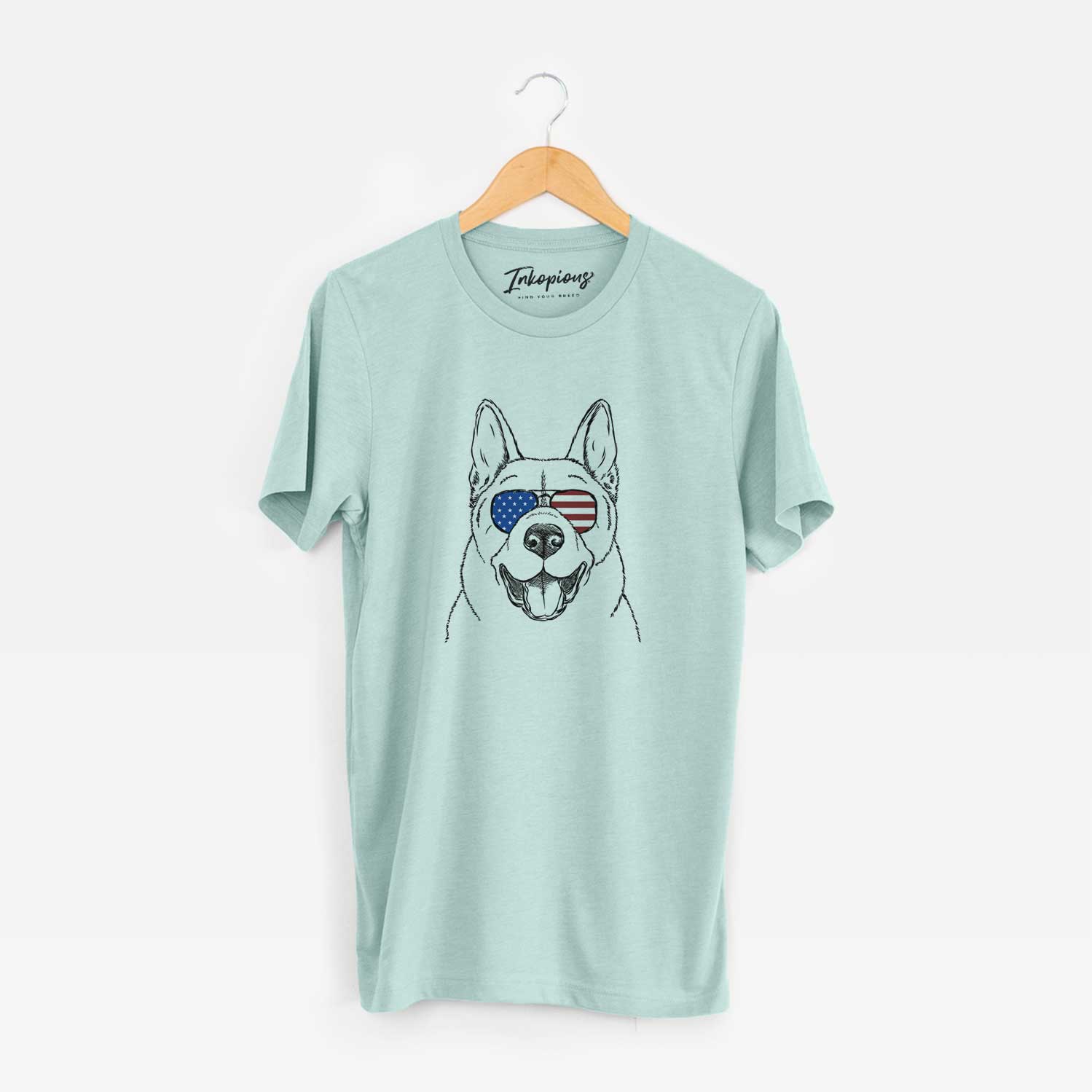 Hand-drawn sketch of Baku the Akita wearing American flag sunglasses on a Heather Sage Unisex crewneck