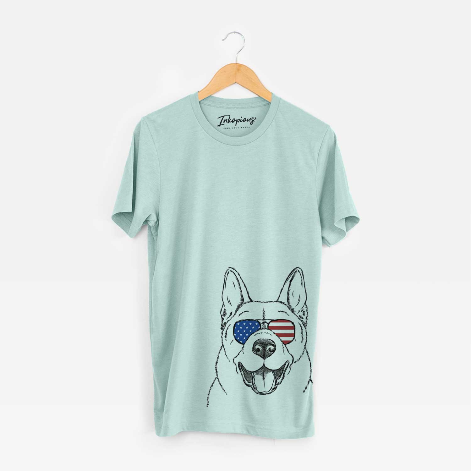 Hand-drawn sketch of Baku the Akita wearing American flag sunglasses on a Heather Sage Unisex crewneck