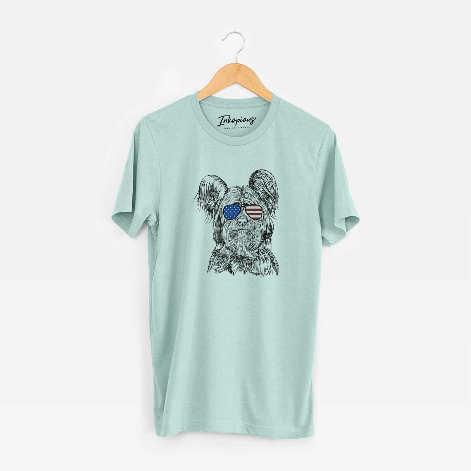 Hand-drawn sketch of Bandit the Skye Terrier wearing American flag sunglasses on a Heather Sage Unisex crewneck